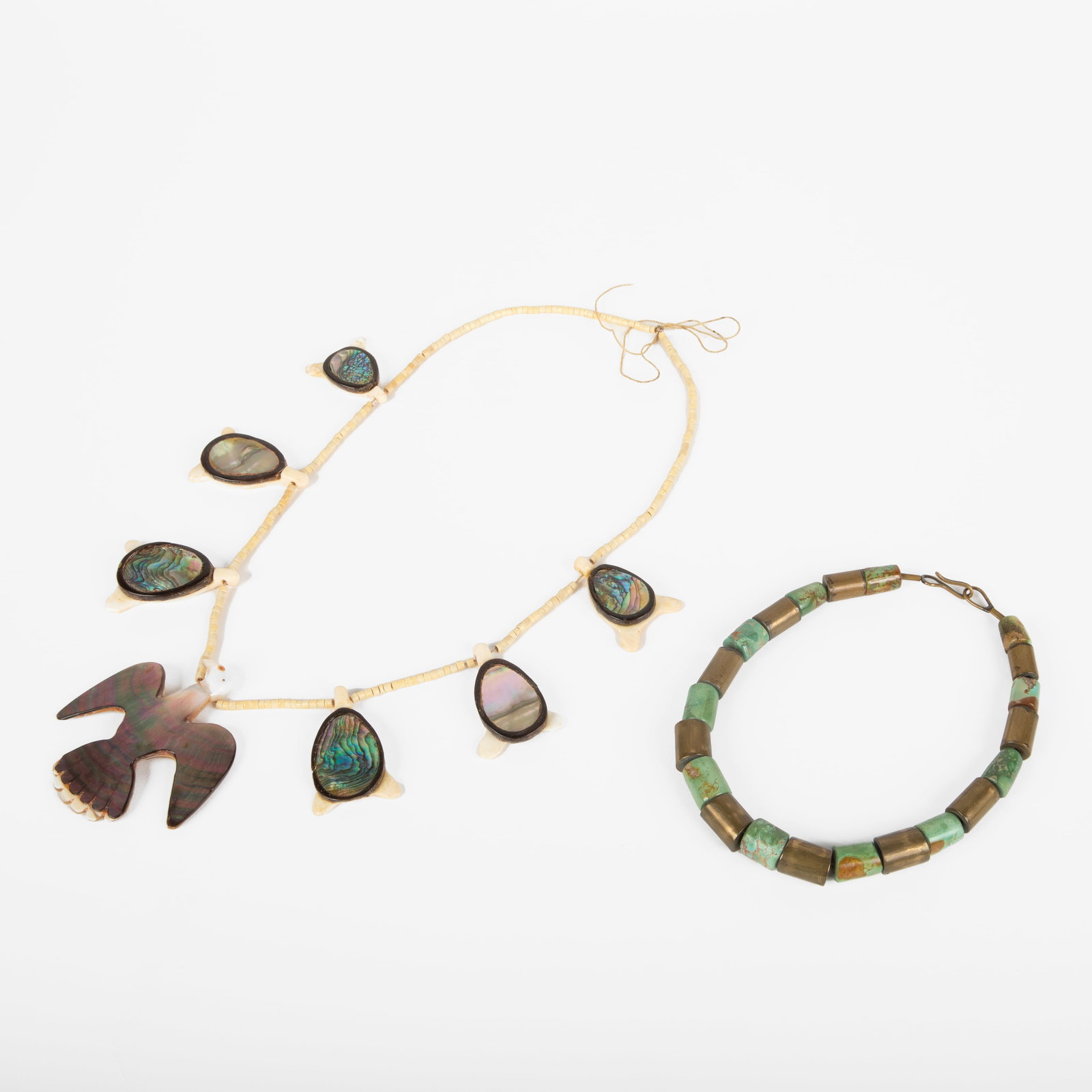 2 Pueblo Beaded Necklaces ca. 1960s: 2 Pueblo Beaded Necklaces ca. 1960s Abalone, Mother of Pearl + Bone Necklace With Eagle Centerpiece overall weight: 85.3 grams Hanging Length: 15 in. (38.1 cm.), Centerpiece: 3 1/8 x 3