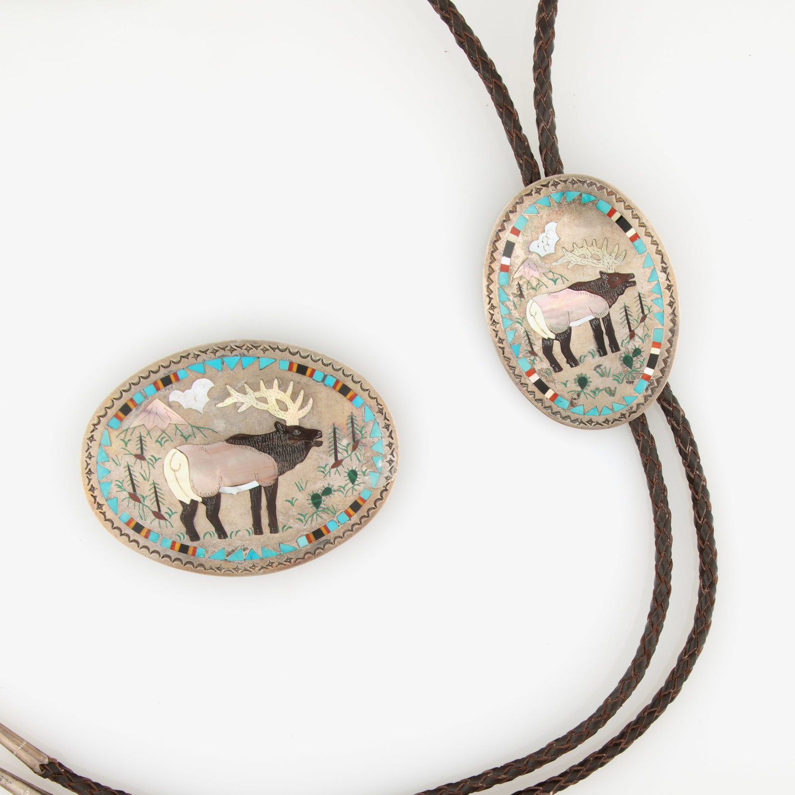 Sam & Esther Guardian, Sterling Silver and Multi-Stone Elk Bolo & Buckle Set, ca. 1980: Sam & Esther Guardian Silver Inlaid Elk Bolo & Buckle Set, ca. 1980 Sterling silver and stone inlay marked verso: S&E GUARDIAN bolo: 3 x 2 1/4 in. (7.6 x 5.7 cm.), hanging length: 22 1/2 in. (57.2 cm.