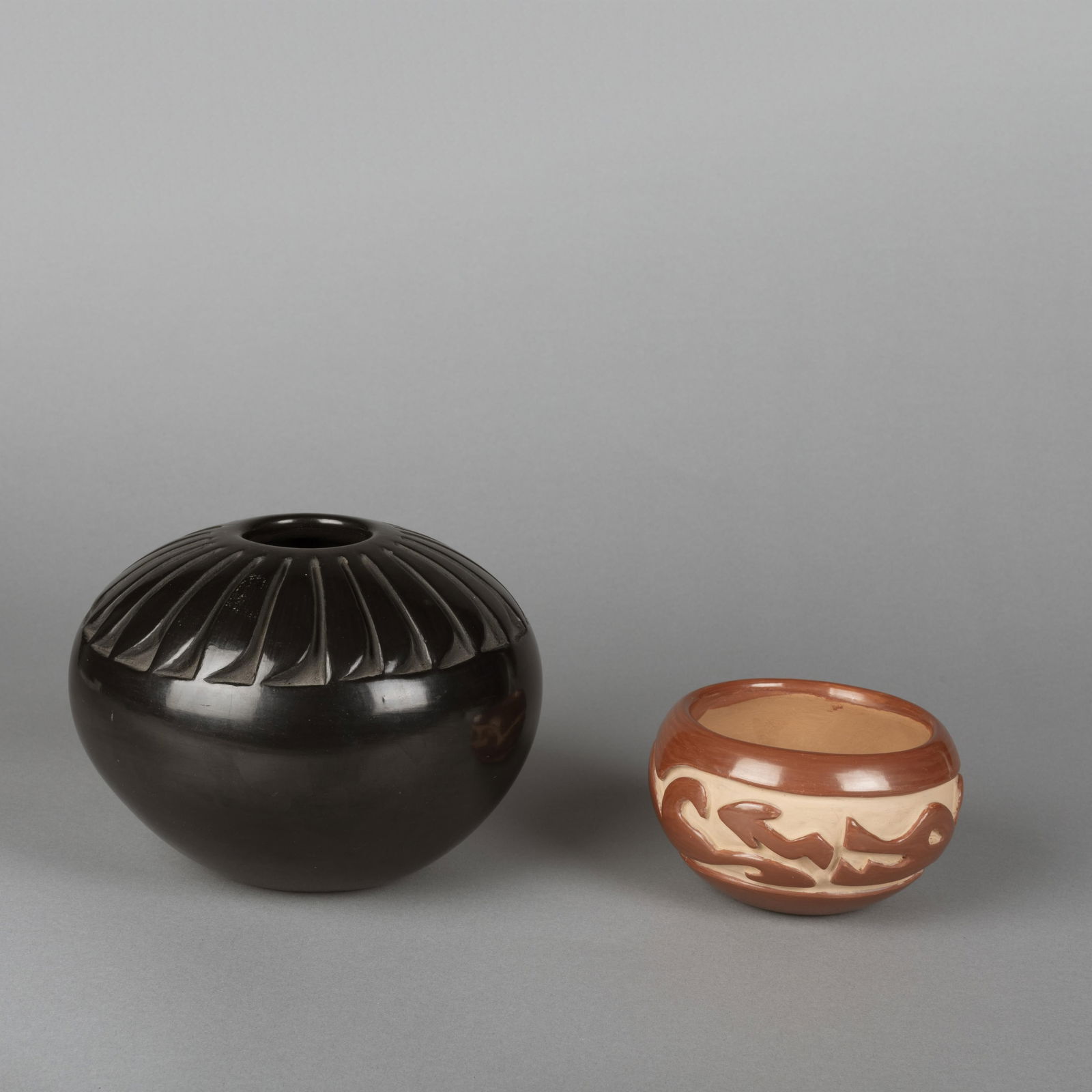 Flora Naranjo + Mary Cain, Lot of Two Pottery Jars: Santa Clara Blackware + Redware: Flora Naranjo + Mary Cain(Santa Clara, 1914 - 2000) + (Santa Clara, 1915 - 2010)Lot of Two Pottery Jars: Santa Clara Blackware + Redwarefired clayFlora Naranjo(Santa Clara, 1914 - 2000)Blackware Pot w