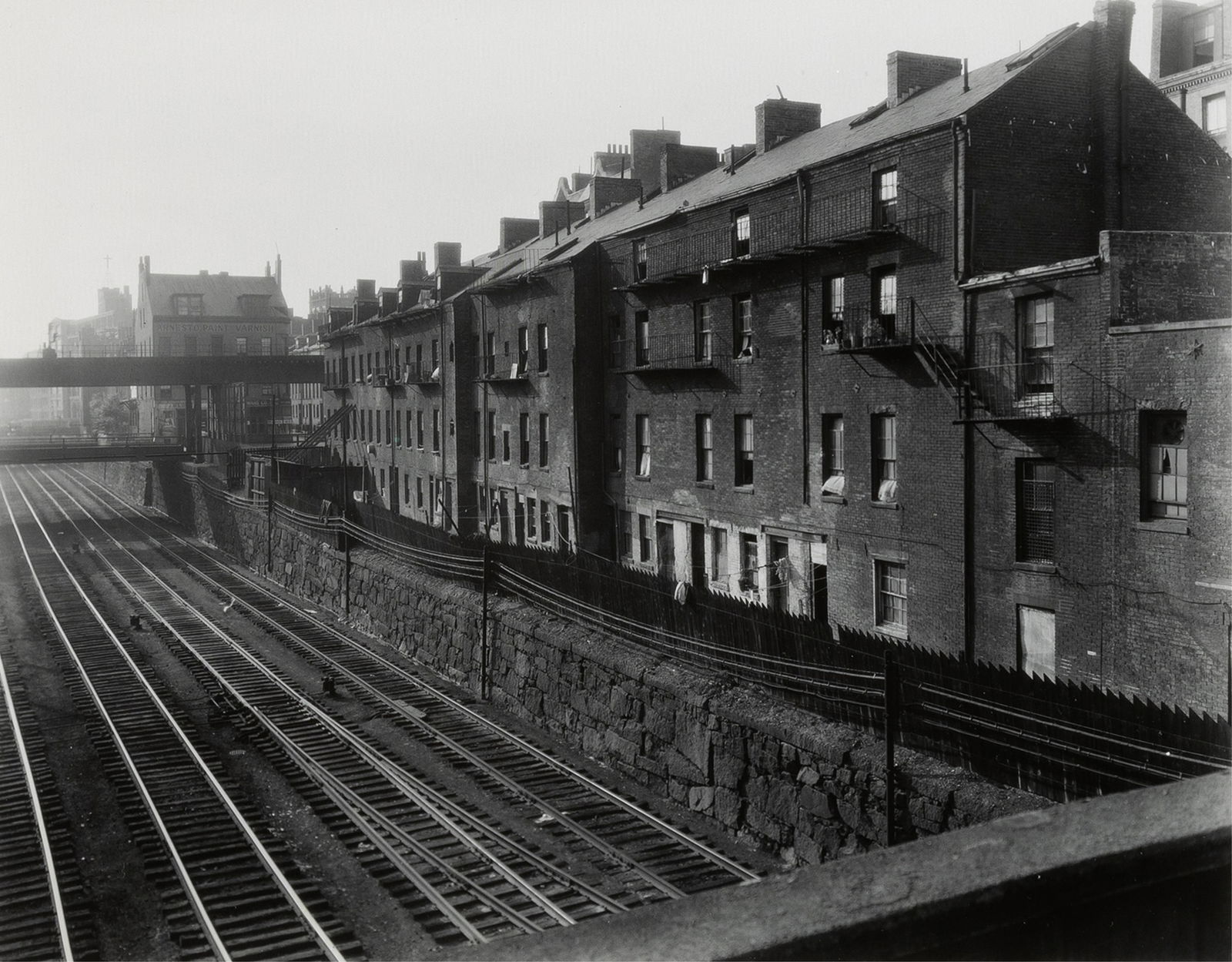 Berenice Abbott, (1898 - 1991), Noanet Street (between Harrison Avenue and Washington Street), 1934,: Berenice Abbott(1898 - 1991)Noanet Street (between Harrison Avenue and Washington Street), 1934gelatin silvergraphite signed on mount lower right: BAink stamp on mount verso: ORIGINAL PHOTOGRAPH / BER