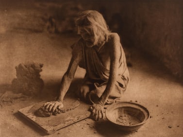 Edward S. Curtis, The Potter Mixing Clay, 1921