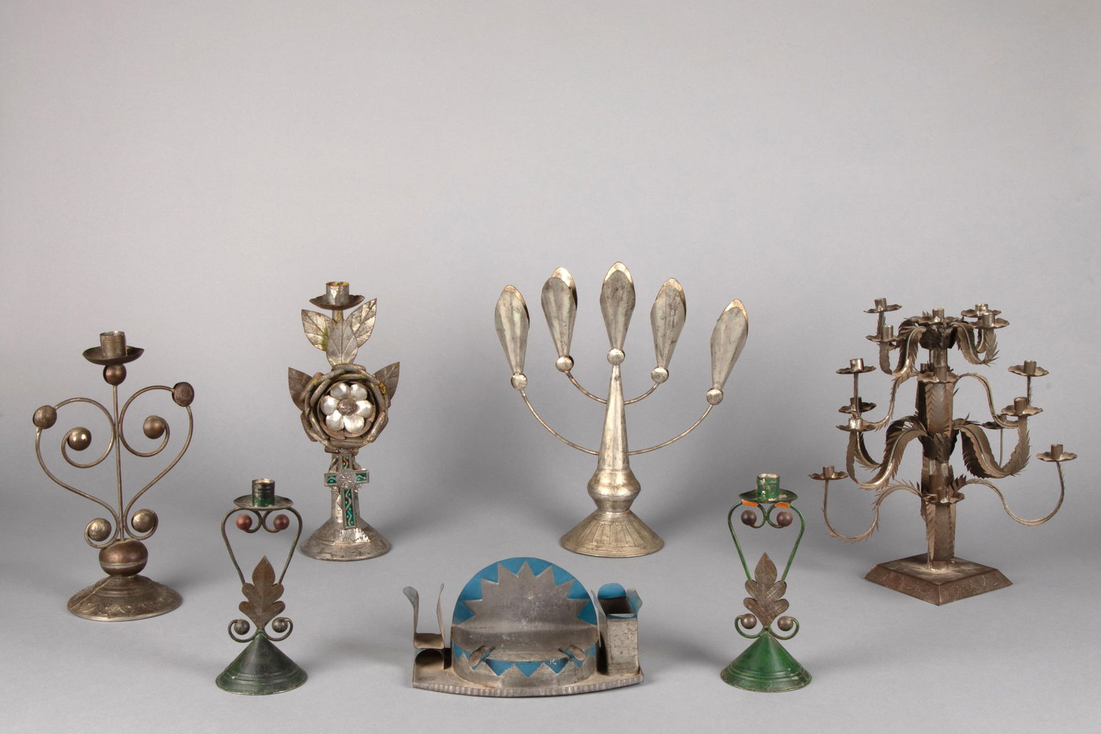 Mexico, Group of Seven Tin Works: Two Candelabras + Four Candlesticks + Decorative Ashtray, ca. 1950 (1 of 2)