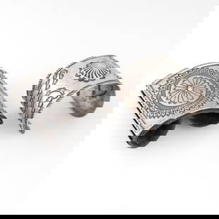 Leo Coriz et al, Group of Two Jewelry Items: Repousse Cuff Bracelet + Silver Ketoh: Leo Coriz et alKewa (Santo Domingo) + Attributed Diné (Navajo), 1913 - 1997Group of Two Jewelry Items: Repousse Cuff Bracelet + Silver Ketohsterling silver, leatherLeo CorizKewa (Santo Domingo), 1913