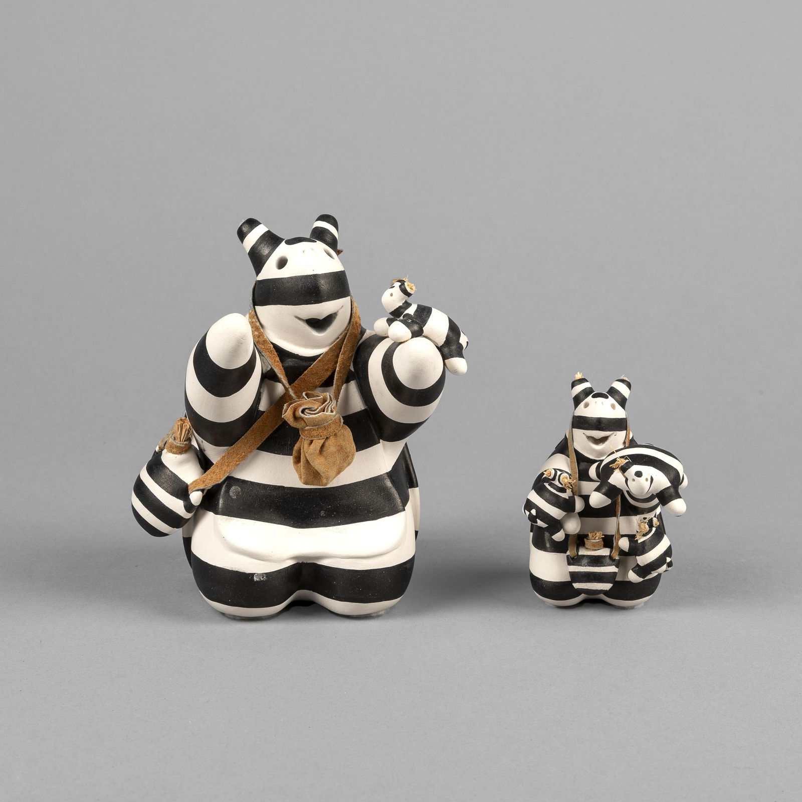 Randy Chitto, Pair of Turtle Koshare Storytellers: Randy ChittoChoctaw, b. 1962Pair of Turtle Koshare Storytellersfired clay, leather, natural fiberseach inscribed: CHITTOsmaller: 3 1/2 x 3 1/2 x 1 1/4 in. (8.9 x 8.9 x 3.2 cm.), larger: 5 1/2 x 4 x 5