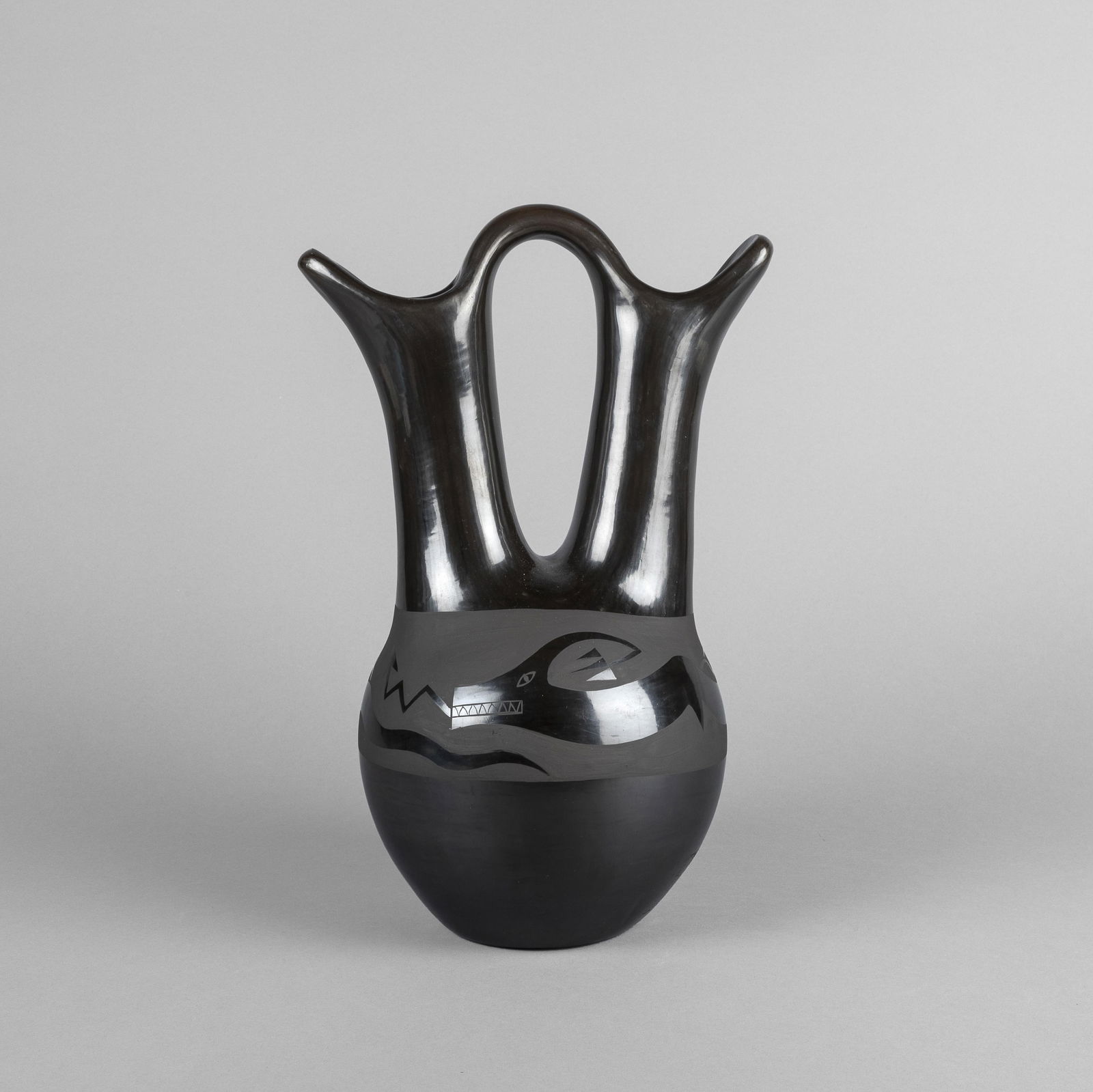 Nicolasa Naranjo, Blackware Wedding Vase with Avanyu, ca. 1980: Nicolasa NaranjoSanta Clara, 1907 - 2002Blackware Wedding Vase with Avanyu, ca. 1980fired clayinscribed: [artist's signature]13 1/2 x 8 1/2 x 7 in. (34.3 x 21.6 x 17.8 cm.) Private Collection, N