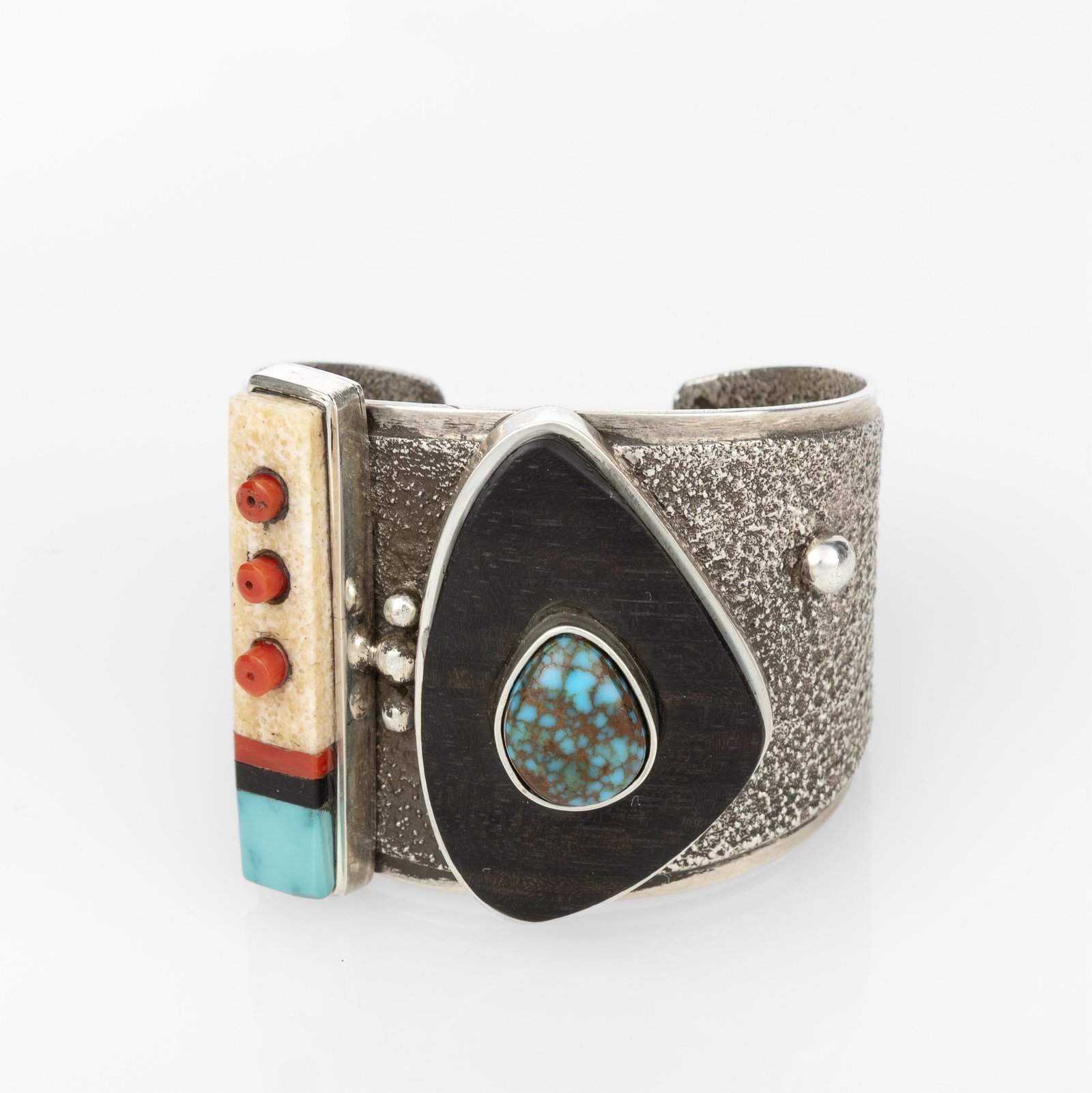 Edison Cummings, Silver Cuff with Mixed Stone Inlay: Edison CummingsDiné (Navajo), b. 1962Silver Cuff with Mixed Stone Inlaysterling silver, ironwood, turquoise, coral, shellstamped: E. CUMMINGSinner circumference: 5 3/8 in. (13.7 cm.), width: 1 7/8 in