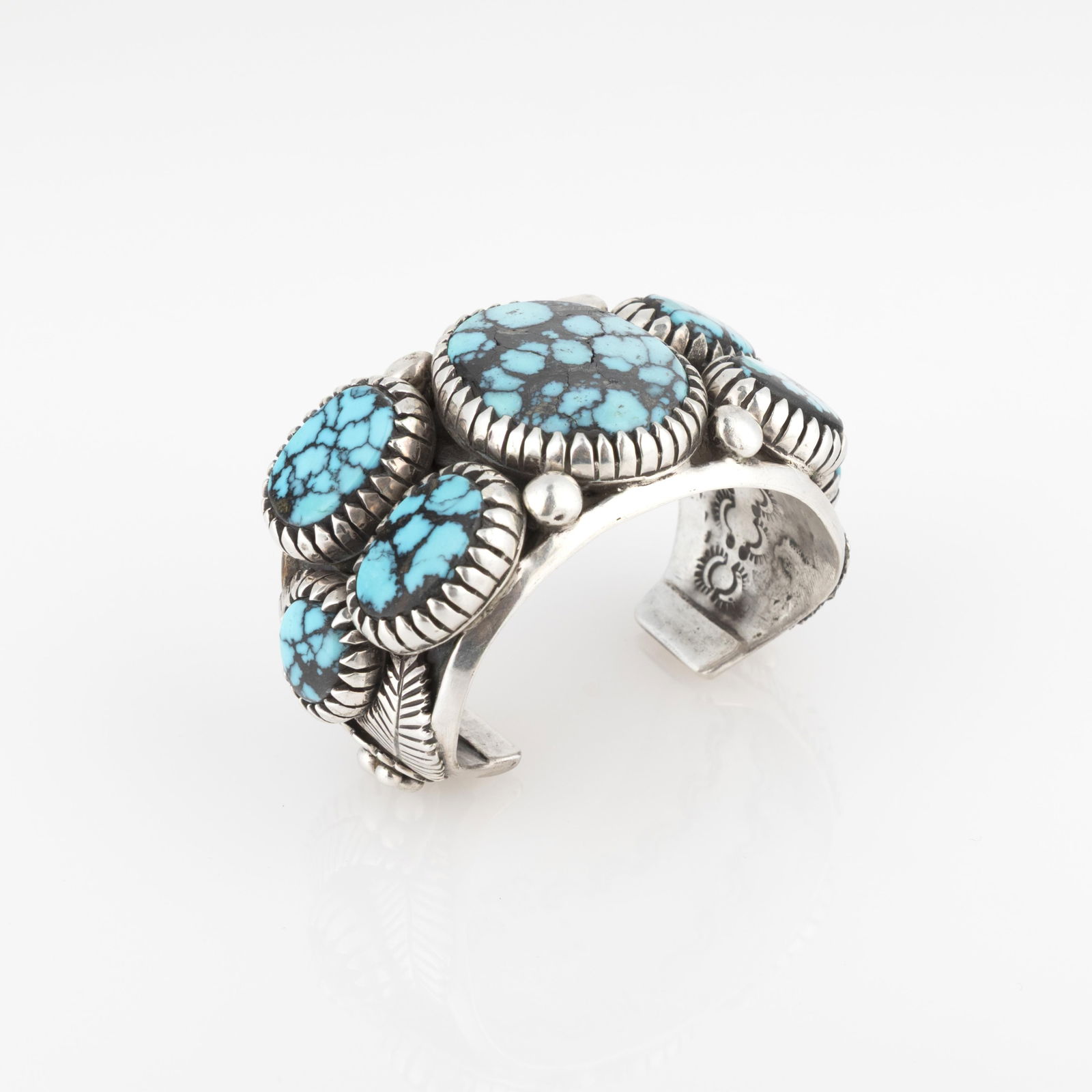 Diné (Navajo), Silver Cuff with Seven Turquoise Cabochons: Diné (Navajo)Silver Cuff with Seven Turquoise Cabochonssilver, turquoisestamped: BRinner circumference: 5 7/8 in. (14.9 cm.), gap: 1 1/4 in. (3.2 cm.), width: 1 1/2 in. (3.8 cm) Private Collection, N