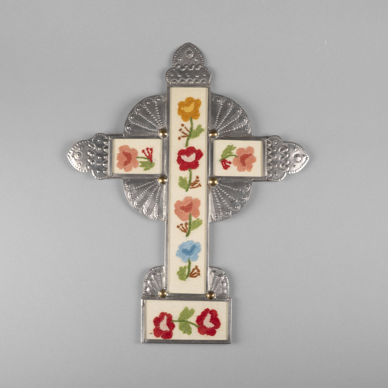 Senaida Romero, Stamped Tin Crucifix with Colcha Stitching, 1989: Senaida Romero New Mexico, 1909 - 2001 Stamped Tin Crucifix with Colcha Stitching, 1989 stamped tin, yarn, fabric inscribed verso: Colcha Stitch / Senaida Romero / 89 17 3/4 x 14 1/4 in. (45.1 x 36.2