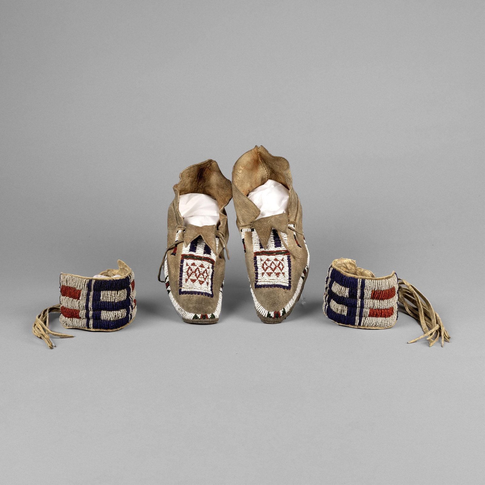 Two Pairs of Beadwork Items: Moccasins + Arm Bands: Two Pairs of Beadwork Items: Moccasins + Arm Bands hide, seed beads Beaded Moccasins 3 7/8 x 3 1/4 x 10 1/8 in. (9.8 x 8.3 x 25.7 cm.) Beaded Arm Bands inner circumference: 11 in. (27.9 cm.) width: 2 