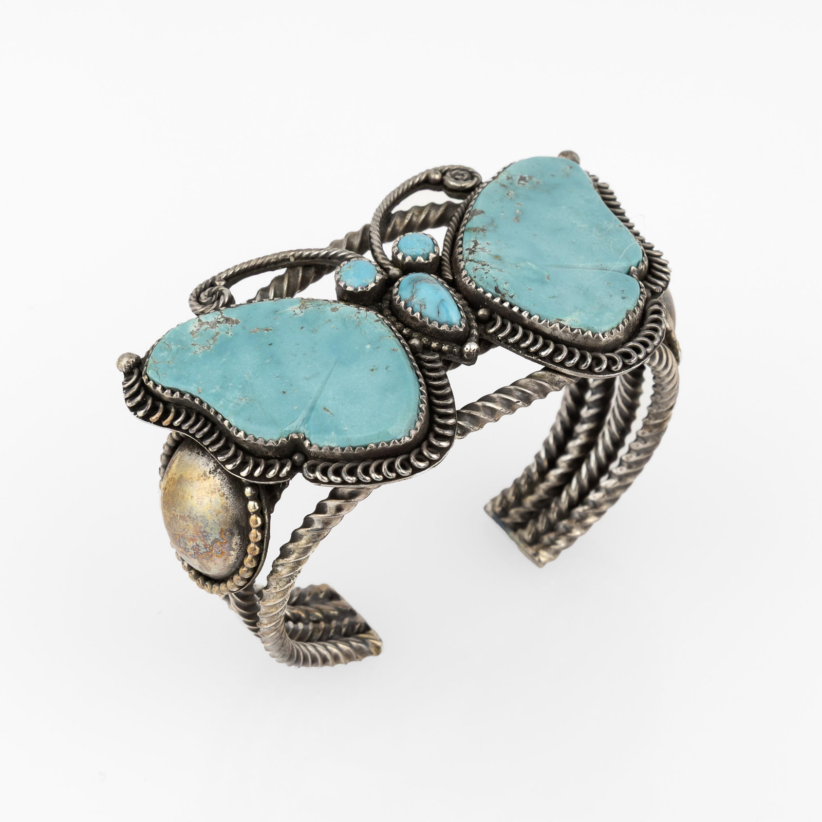 Liz Wallace, Turquoise and Silver Butterfly Cuff: Liz Wallace Diné (Navajo)/Washoe/Maidu, b. 1975 Turquoise and Silver Butterfly Cuff turquoise, silver inscribed: [artist's hallmark] gross weight: 77 g. inner circumference: 5 in. (12.7 cm.), gap: 7/