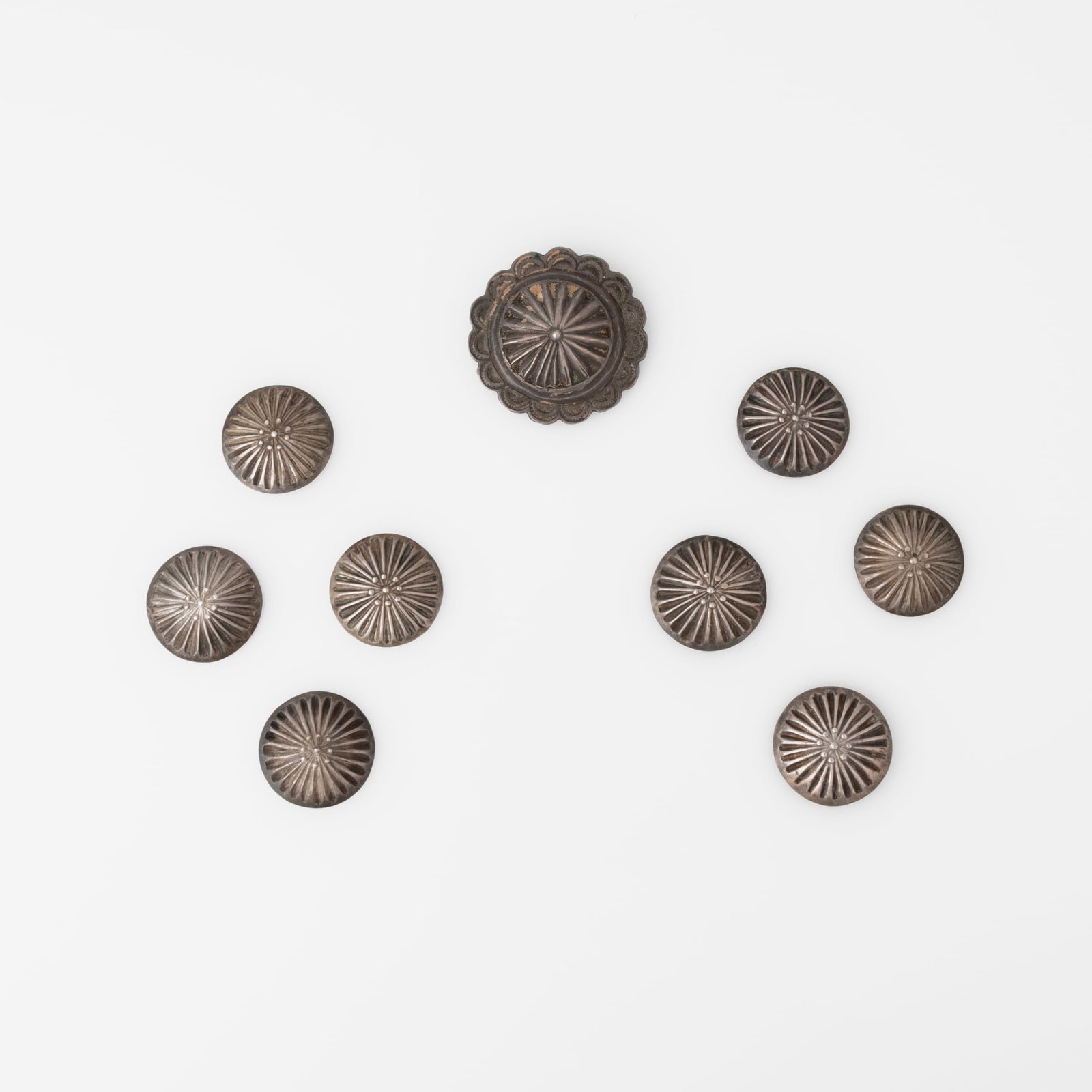 Diné (Navajo), Group of Eight Silver Buttons + Pin, ca. 1935