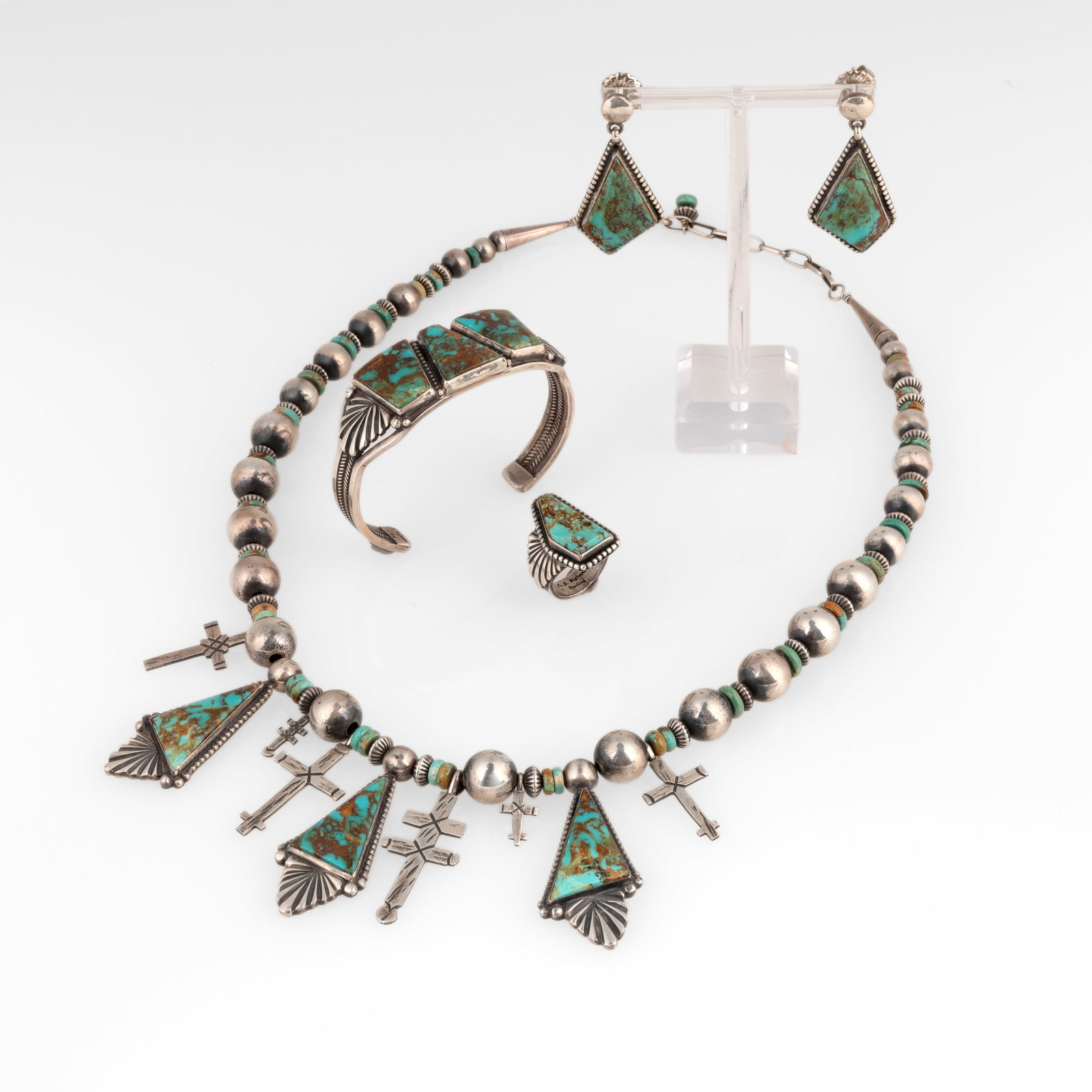 E. G. Bighand et al, Suite of Four Jewelry Items: Earrings + Necklace + Ring + Cuff: E. G. Bighand et al Diné (Navajo), 20th Century Suite of Four Jewelry Items: Earrings + Necklace + Ring + Cuff sterling silver, turquoise E. G. Bighand Diné (Navajo), 20th Century Silver Drop Earrin