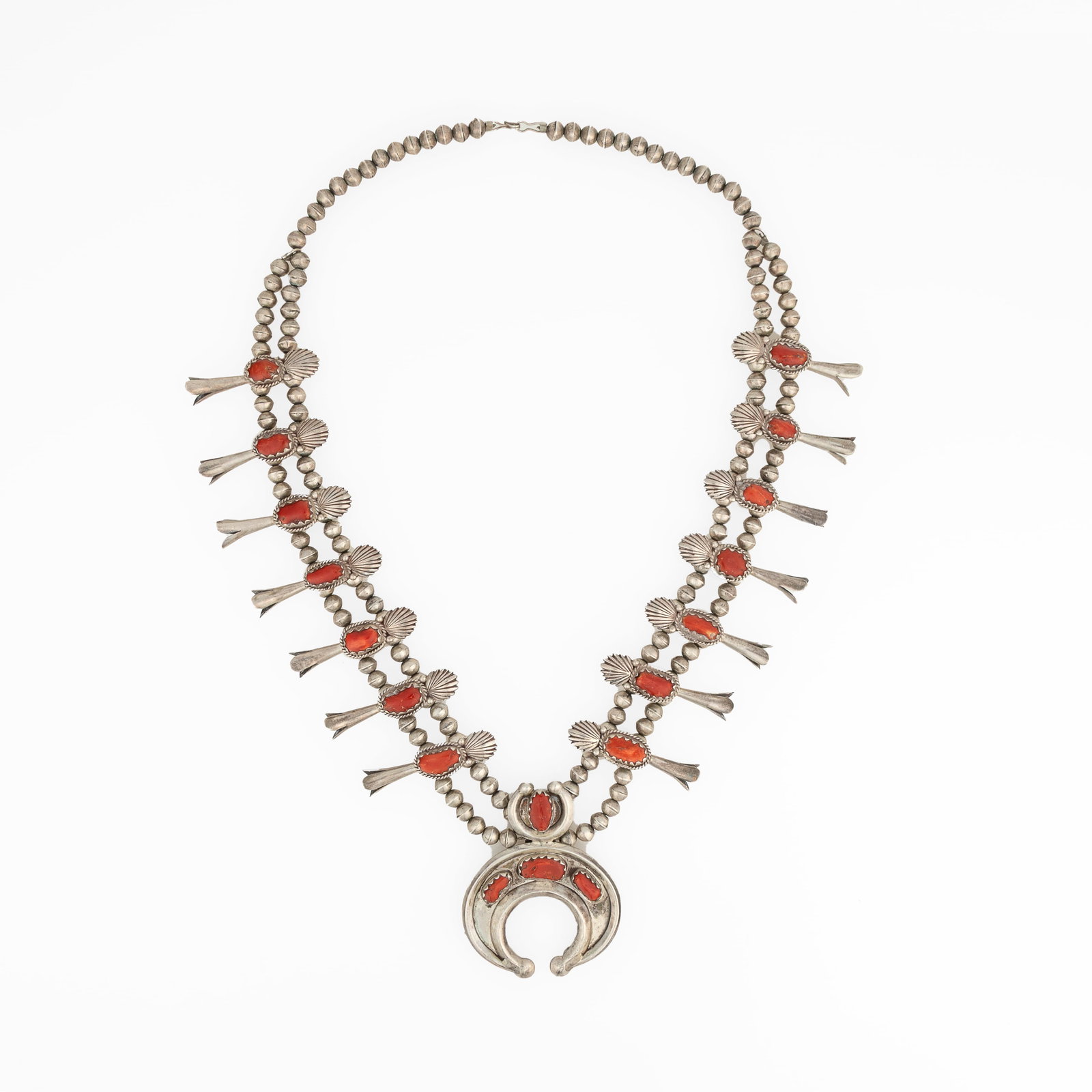 Diné (Navajo), Silver Squash Blossom Necklace with Coral Cabochons, ca. 1970: Diné (Navajo) Silver Squash Blossom Necklace with Coral Cabochons, ca. 1970 silver, coral gross weight: 174 g. hanging length: 15 1/2 in. (39.4 cm.), naja: 2 3/4 x 2 1/2 in. (7 x 6.4 cm.) Private Col