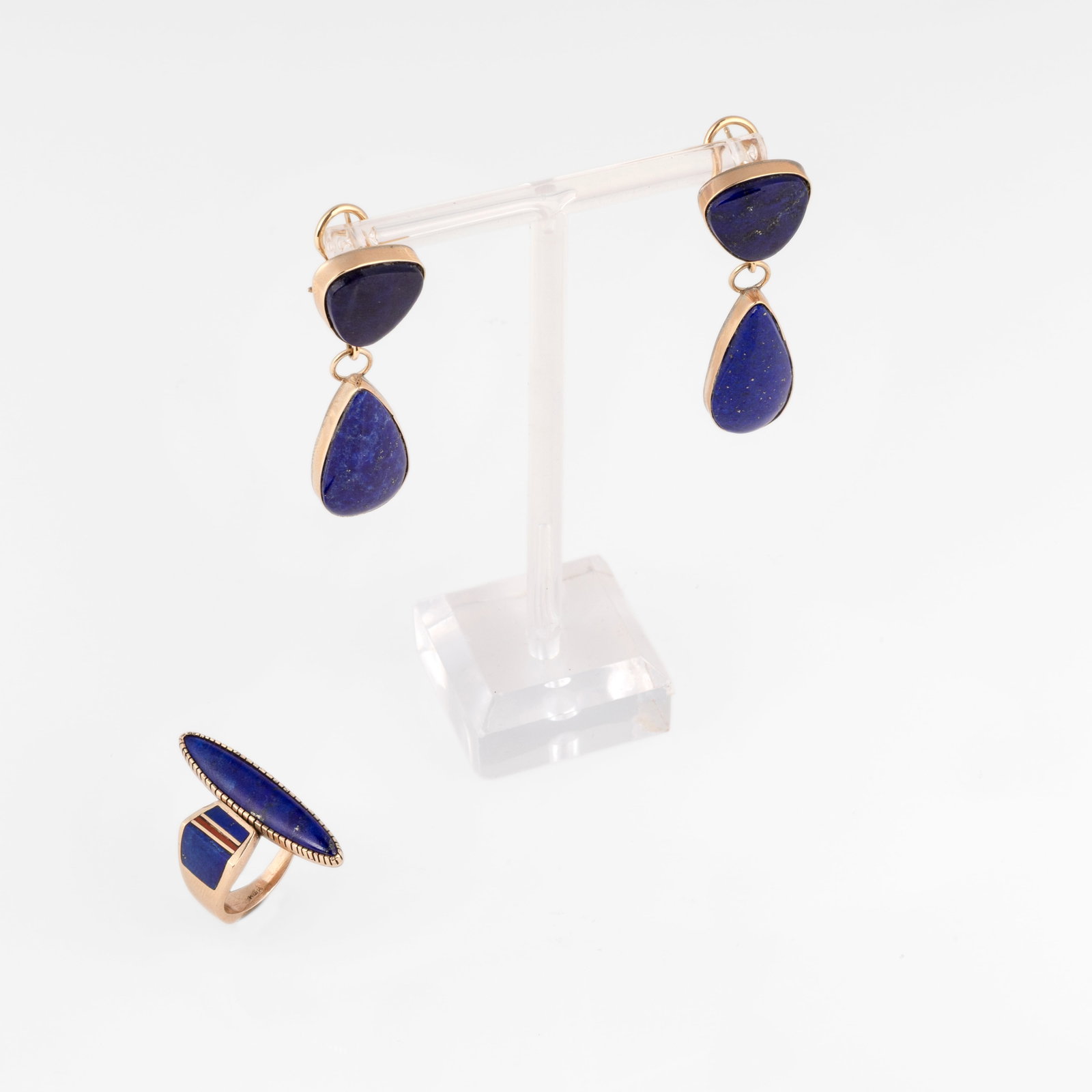 Verdy Jake et al, Set of Lapis Jewelry Items: Ring + Earrings: Verdy Jake et al Diné (Navajo), b. 1970s Set of Lapis Jewelry Items: Ring + Earrings lapis, coral, gold Verdy Jake Diné (Navajo), b. 1970s Teardrop Lapis + Gold Earrings stamped: JAKE / 14K each: