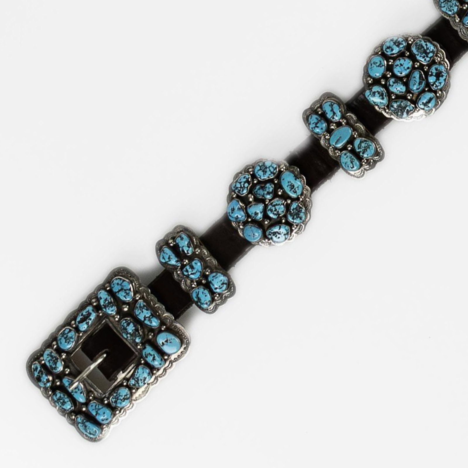 Daniel Martinez, Turquoise Cluster Concho Belt, ca. 1960: Daniel Martinez Diné (Navajo), 20th Century Turquoise Cluster Concho Belt, ca. 1960 turquoise, sterling silver stamped: Sterling / D M gross weight: 580 g. belt: 2 3/8 x 47 1/2 in. (6 x 120.7 cm.), e