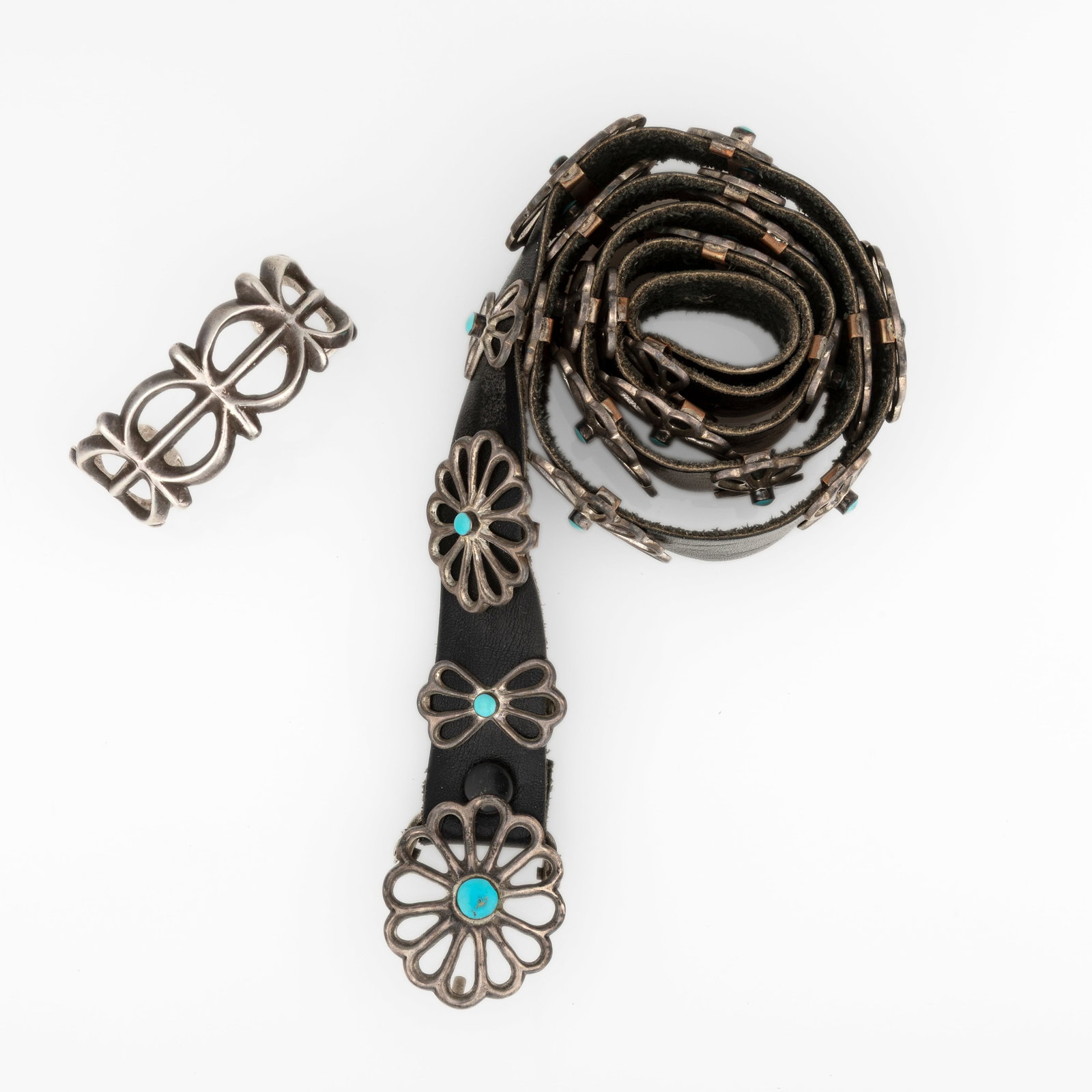 Diné (Navajo), Two Sandcast Silver Jewelry Works: Concho Belt + Cuff, ca. 1955: Diné (Navajo) Two Sandcast Silver Jewelry Works: Concho Belt + Cuff, ca. 1955 leather, silver, turquoise Sandcast Turquoise and Silver Concho Belt belt: 33 3/4 x 1 in. (85.7 x 2.5 cm.), buckle: 1 3/8