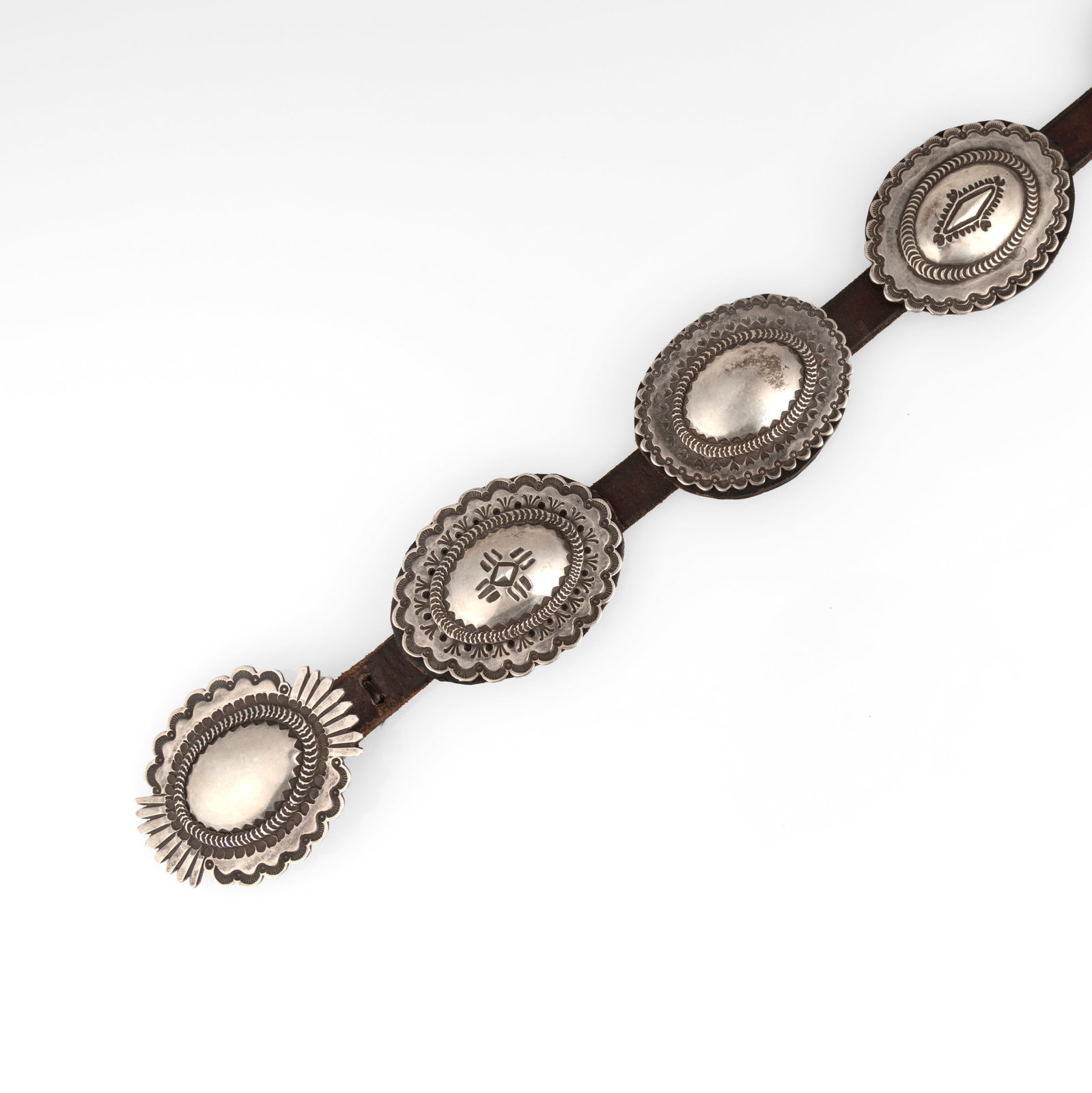 Frank Valdez, Stamped Sterling Silver Concho Belt, ca. 1980: Frank Valdez 20th/21st Century Stamped Sterling Silver Concho Belt, ca. 1980 sterling silver stamped: VALDEZ / STERLING gross weight: 457 g. belt: 2 1/2 x 50 3/4 in. (6.4 x 128.9 cm.), each concho: 2