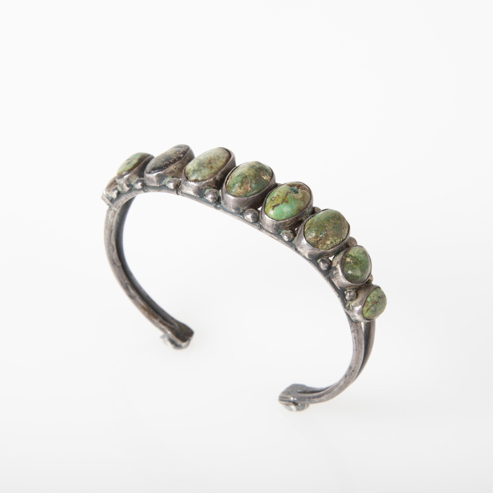 Diné (Navajo), Silver and Turquoise Row Cuff, ca. 1930 - 1945: Diné (Navajo) Silver and Turquoise Row Cuff, ca. 1930 - 1945 silver, turquoise gross weight: 27 g. inner circumference: 5 5/8 in. (14.3 cm.), gap: 1 in. (2.5 cm.),width: 1/2 in. (1.3 cm.) Private Col
