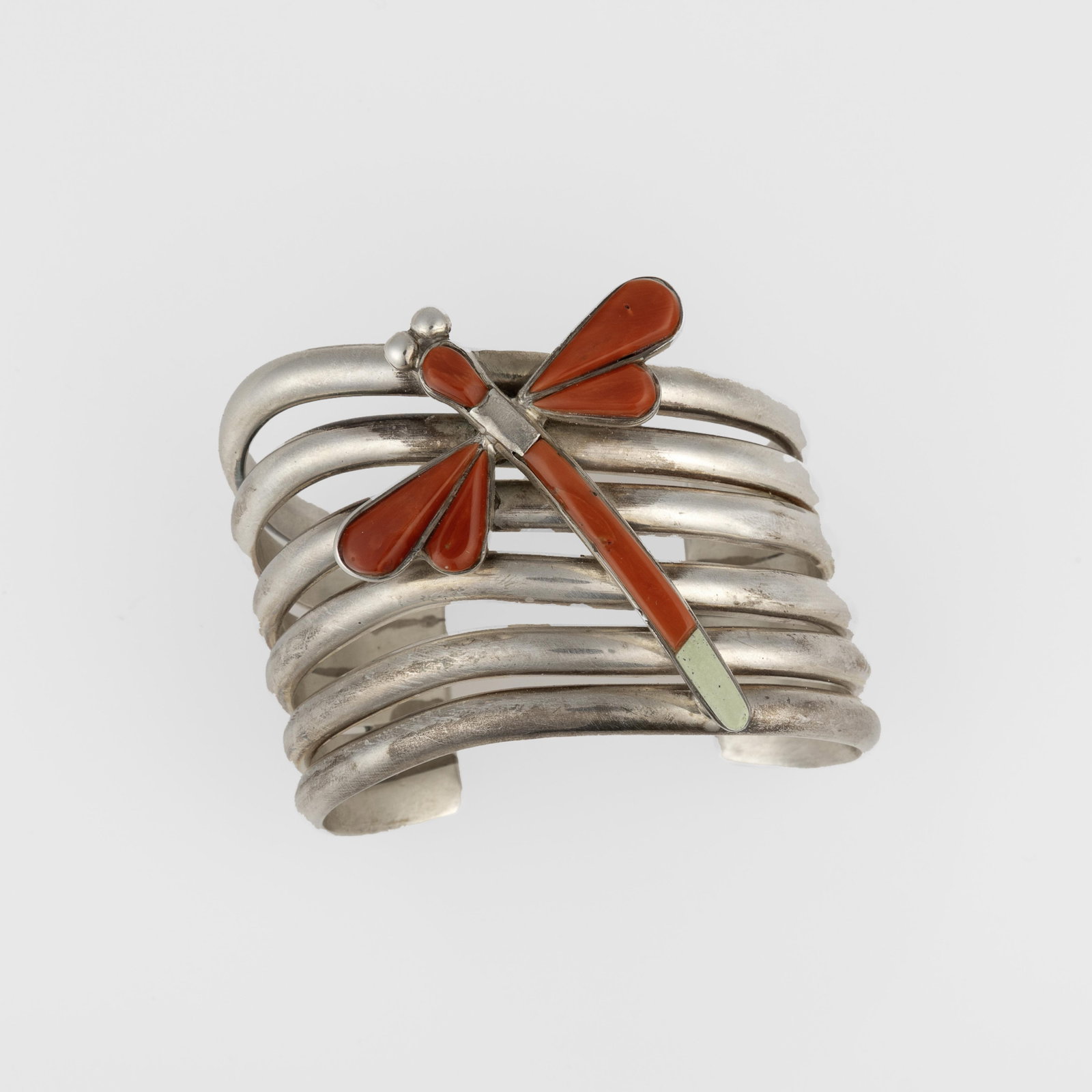 Michael [Na Na Ping] Garcia, Coral and Turquoise Dragonfly Cuff, ca. 2010: Michael [Na Na Ping] Garcia Pascua Yaqui, b. 1953 Coral and Turquoise Dragonfly Cuff, ca. 2010 silver, coral, turquoise stamped: NA NA PING / STERLING gross weight: 103 g. inner circumference: 5 in. (