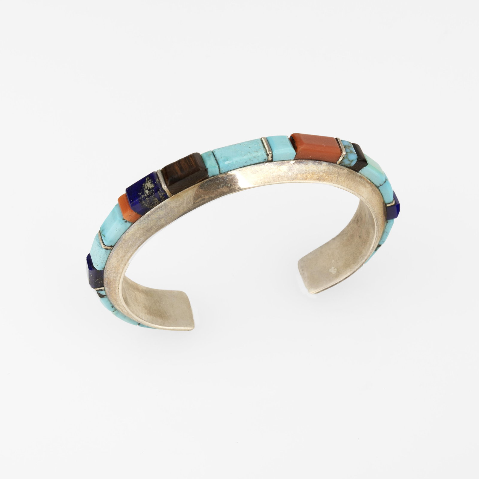 Wes Willie, Mixed Stone Inlay Cuff: Wes Willie Diné (Navajo), 20th/21st Century Mixed Stone Inlay Cuff iron wood, lapis, coral, turquoise, silver stamped: W / STERLING gross weight: 42 g. inner circumference not including gap: 5 in. (1