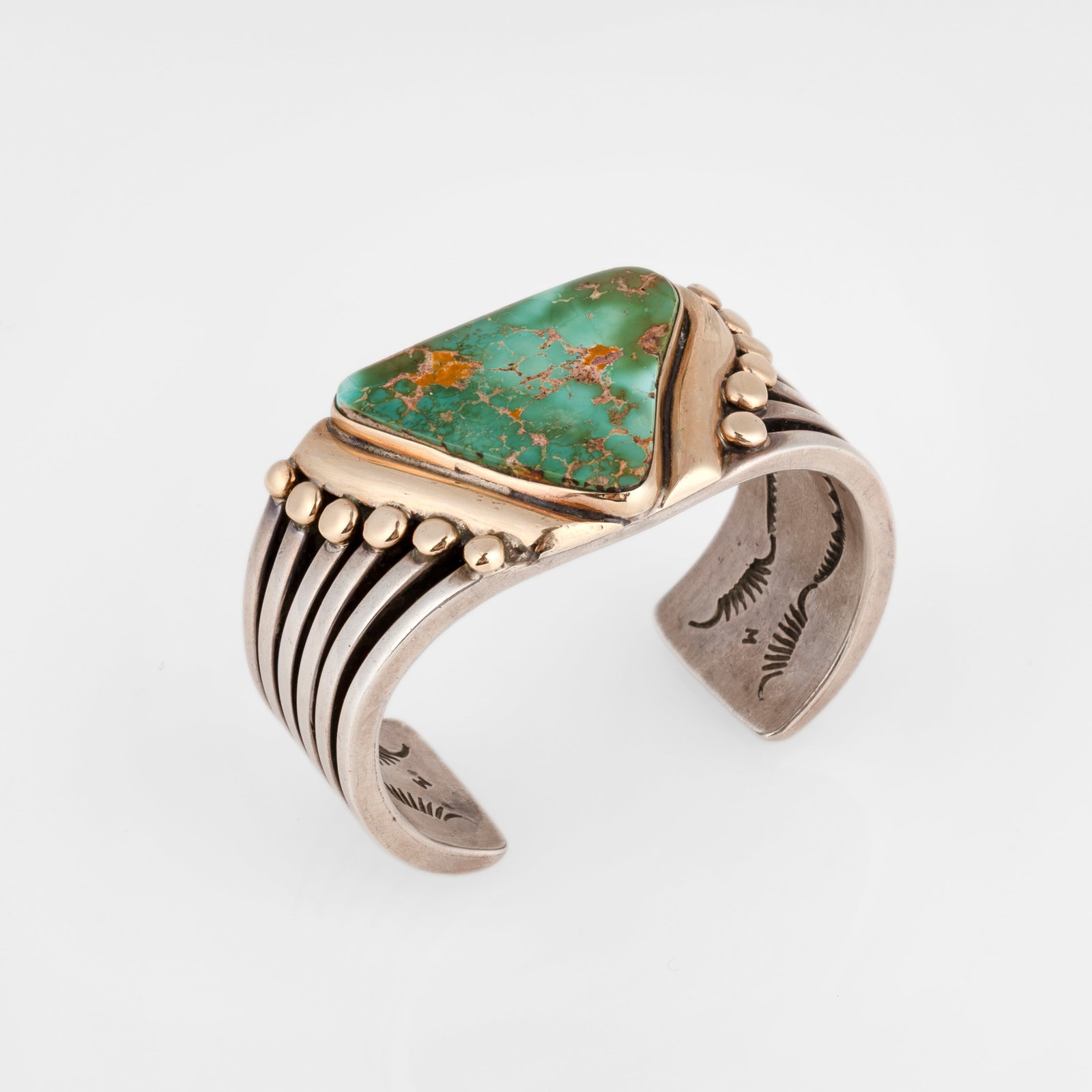 Orville Z. Tsinnie, Gold and Silver Cuff with Large Turquoise Cabochon: Orville Z. Tsinnie Dine (Navajo), 1943 - 2017 Gold and Silver Cuff with Large Turquoise Cabochon gold, sterling silver, turquoise stamped: STERLING / Orville Tsinnie / Shiprock, N.M. gross weight: 138