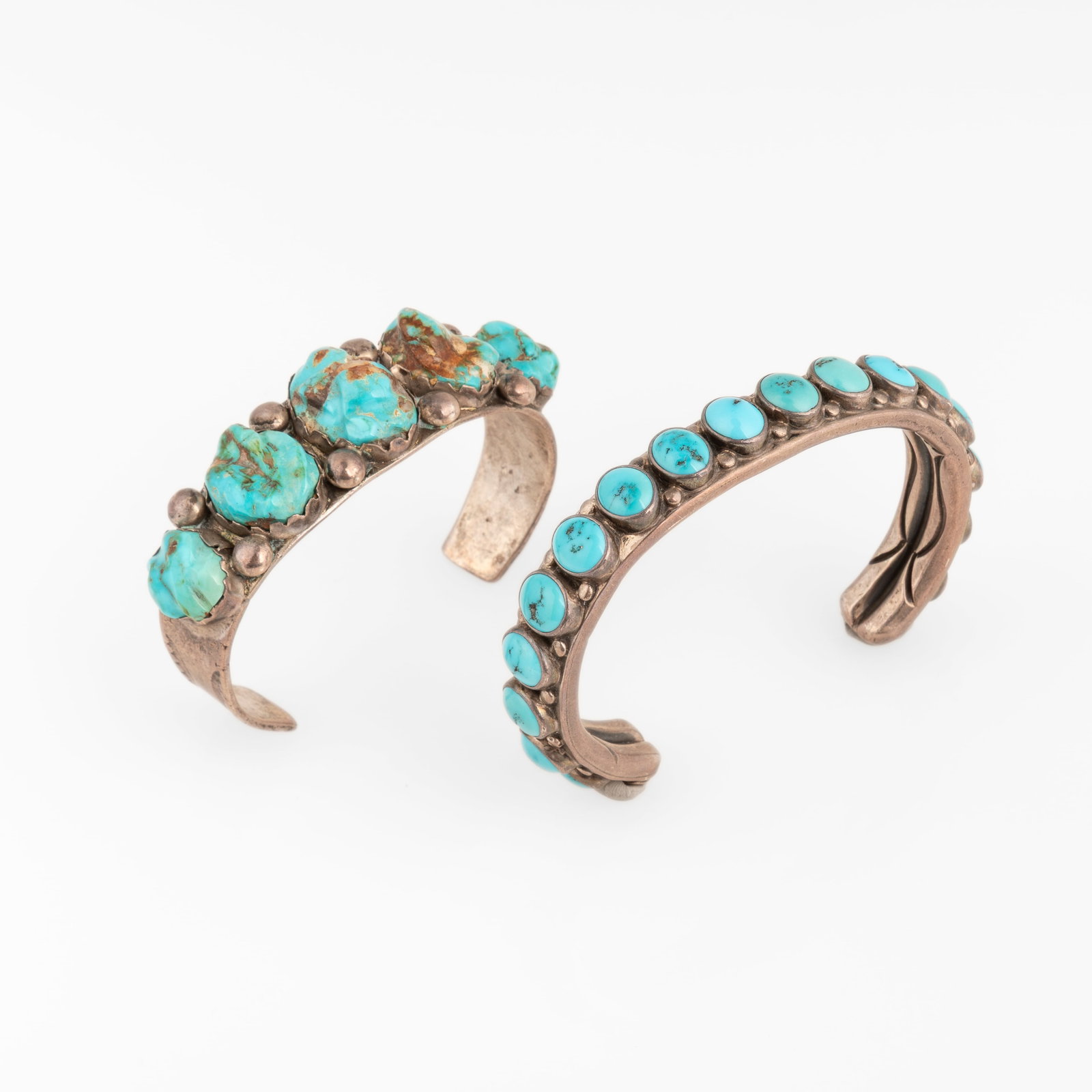 Orville Z. Tsinnie et al, Two Silver Cuffs with Turquoise Cabochons: Seventeen Stone + Five Stone: Orville Z. Tsinnie et al Diné (Navajo), 1943 - 2017 Two Silver Cuffs with Turquoise Cabochons: Seventeen Stone + Five Stone sterling silver, turquoise Orville Z. Tsinnie Diné (Navajo), 1943 - 2017 S