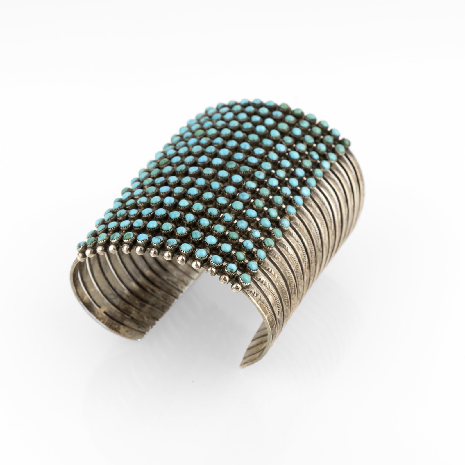 Zuni, Fifteen-Row Turquoise Needlepoint Cuff, ca. 1950: Zuni Fifteen-Row Turquoise Needlepoint Cuff, ca. 1950 turquoise, silver inscribed: U. U. E. X. gross weight: 116 g. inner circumference: 5 1/8 in. (13 cm.), gap: 1 1/8 in. (2.9 cm.), width: 3 in.