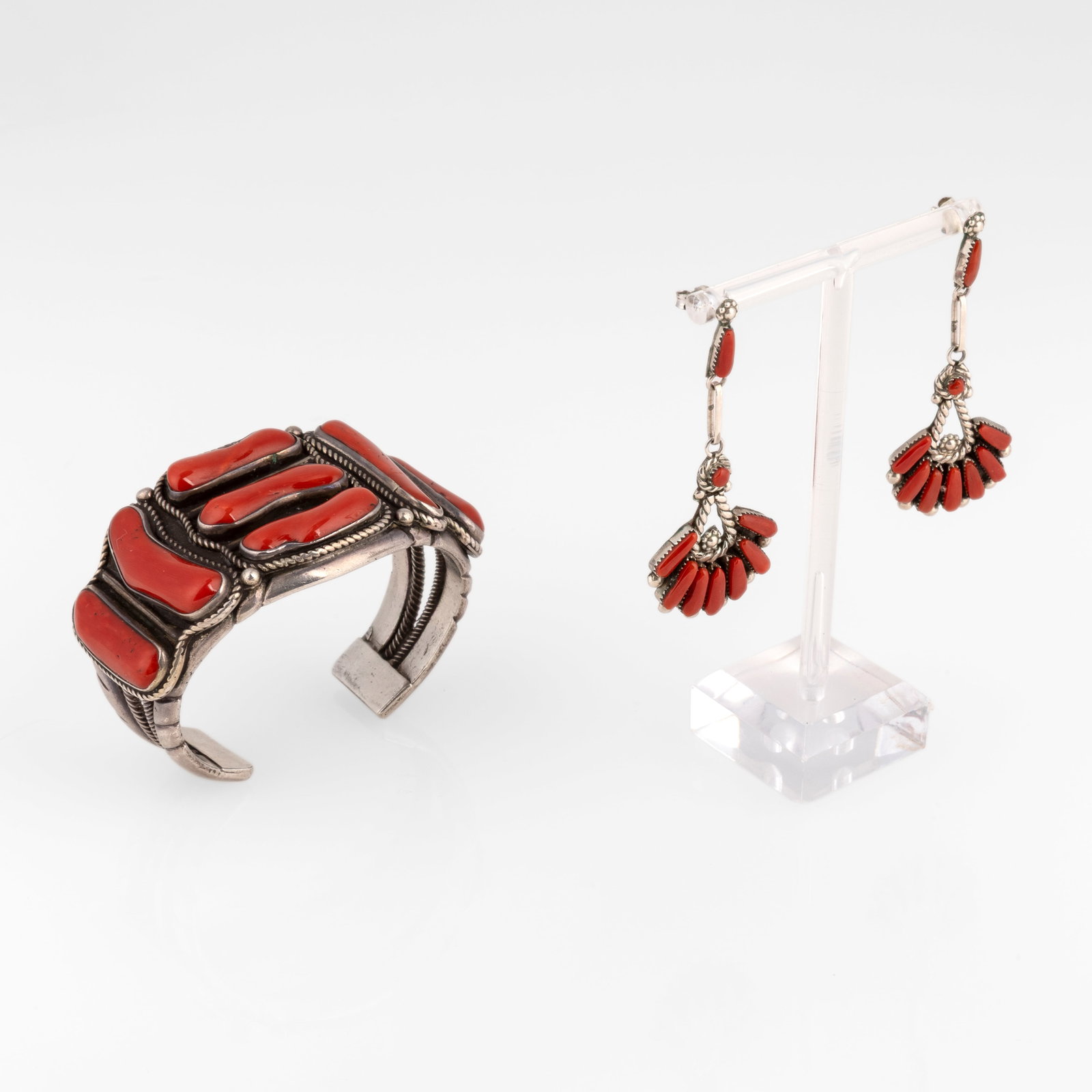 Southwest Style, Sterling and Coral Jewelry Set: Cuff + Earrings, ca. 1975: Southwest Style Sterling and Coral Jewelry Set: Cuff + Earrings, ca. 1975 sterling silver, coral Sterling Silver and Coral Cuff inner circumference: 5 5/8 in. (14.3 cm.), gap: 1 1/4 in. (3.2 cm.),