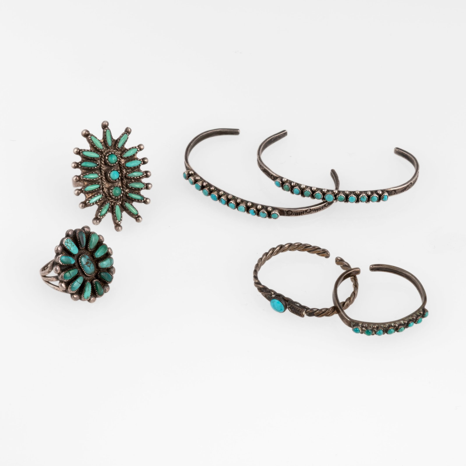Group of Six Silver and Turquoise Jewelry Items: Four Cuffs + Two Rings: Group of Six Silver and Turquoise Jewelry Items: Four Cuffs + Two Rings silver, turquoise Two Medium Turquoise Cuffs inner circumference: 4 1/4 in. (10.8 cm.), gap: 1 1/2 in. (3.8 cm.), width: 1/8 in.