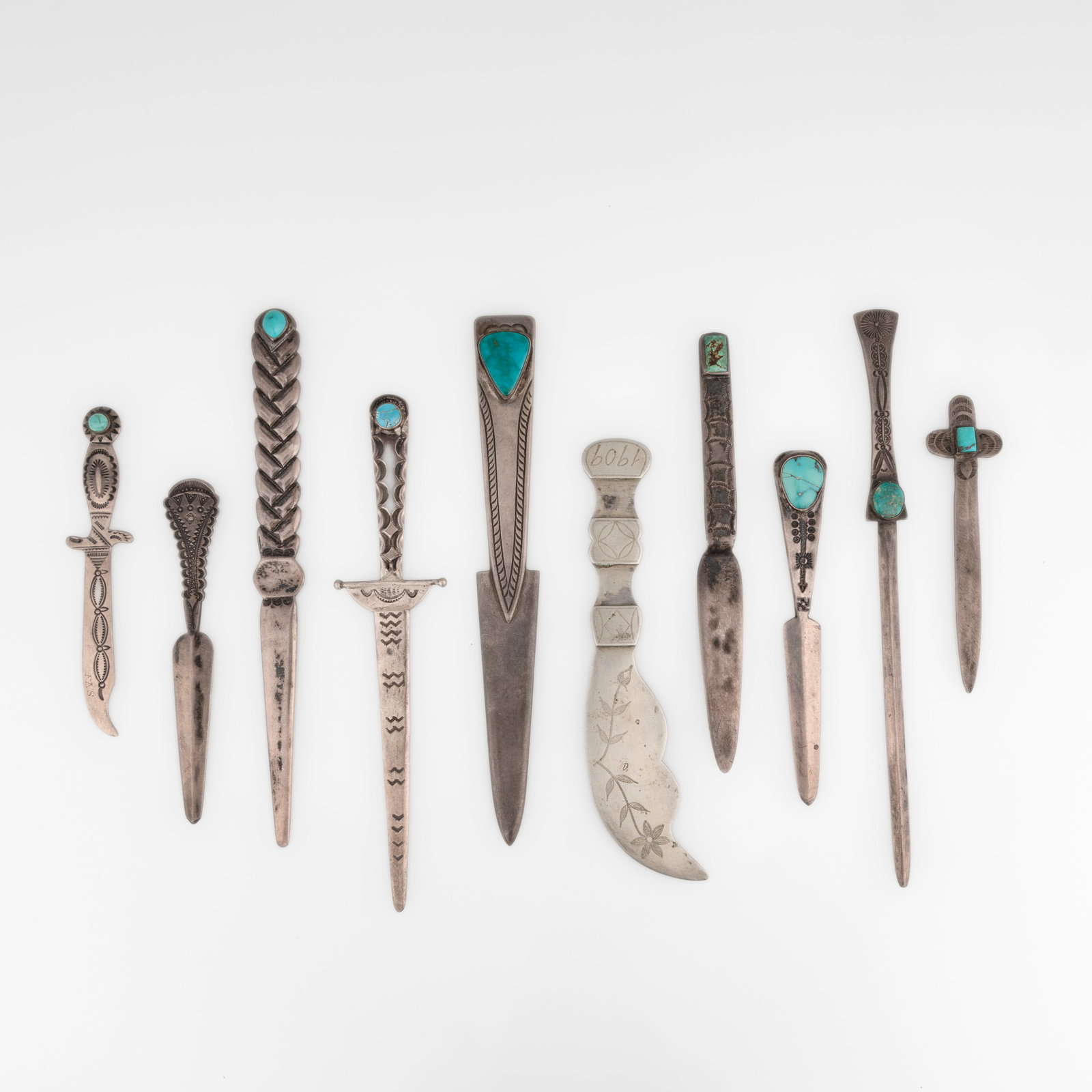 Group of Ten Silver and Turquoise Letter Openers: Group of Ten Silver and Turquoise Letter Openers silver, turquoise gross weight: 328 g. largest: 8 1/4 x 5/8 in. (21 x 1.6 cm.), smallest: 4 1/4 x 1 1/8 in. (10.8 x 2.9 cm.) Private Collection, New Me