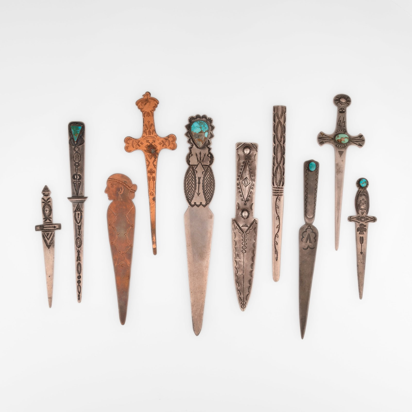 Group of Ten Letter Openers: Eight Silver and Turquoise + Two Copper: Group of Ten Letter Openers: Eight Silver and Turquoise + Two Copper silver, turquoise, copper silver gross weight: 231 g. copper gross weight: 38 g. largest: 8 5/8 x 1 1/8 in. (21.9 x 2.9 cm.), small