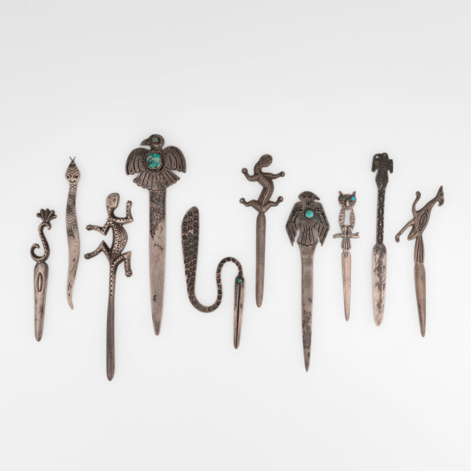 Group of Ten Silver and Turquoise Letter Openers: Group of Ten Silver and Turquoise Letter Openers silver, turquoise gross weight: 327 g. largest: 7 1/4 x 2 1/4 in. (18.4 x 5.7 cm.), smallest: 5 x 1 in. (12.7 x 2.5 cm.) Private Collection, New Mexico
