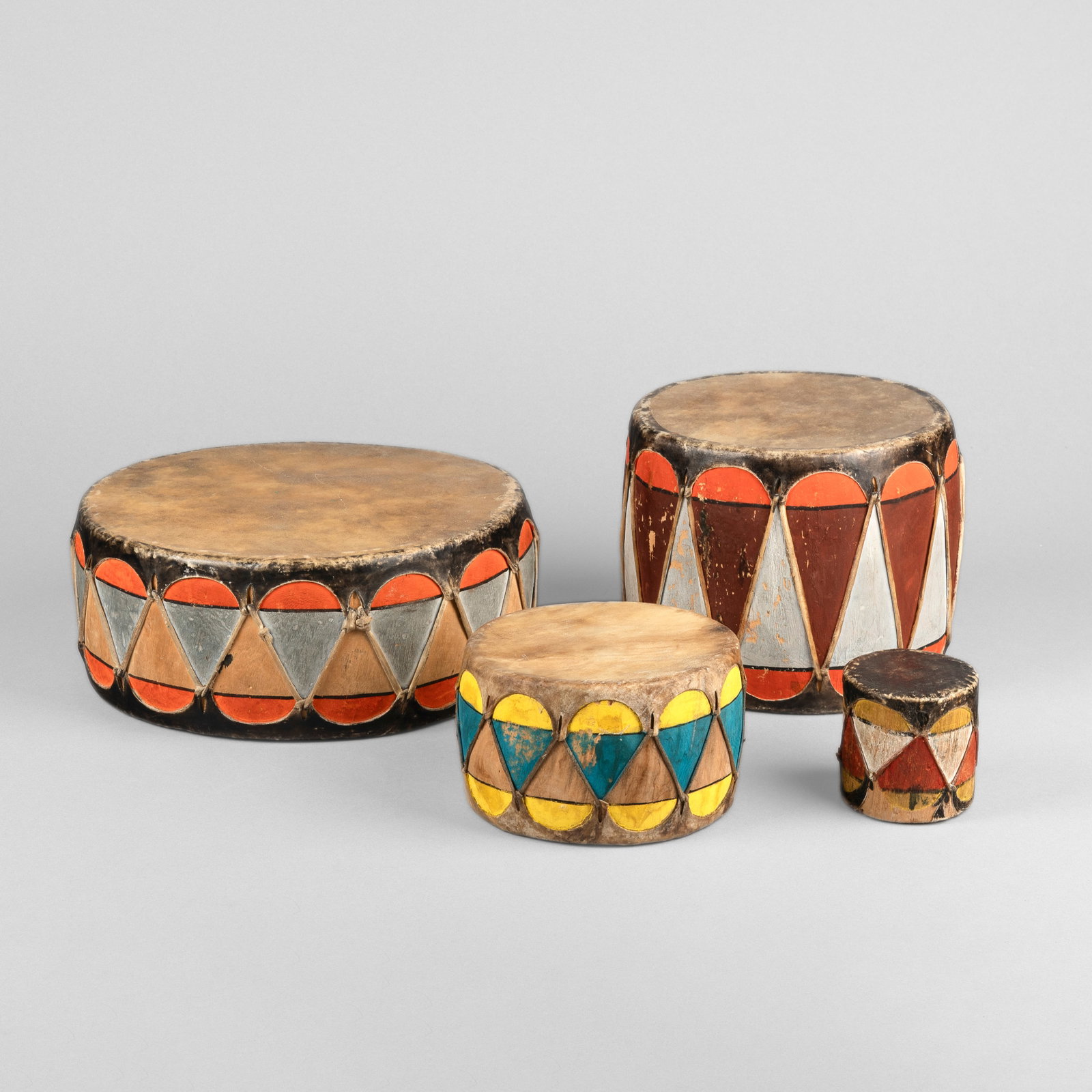 Pueblo, Group of Four Drums: Pueblo Group of Four Drums carved and painted wood, hide smallest: 3 7/8 x 2 3/4 in. (9.8 x 7 cm.), largest: 4 x 10 in. (10.2 x 25.4 cm.) Private Collection, Indiana