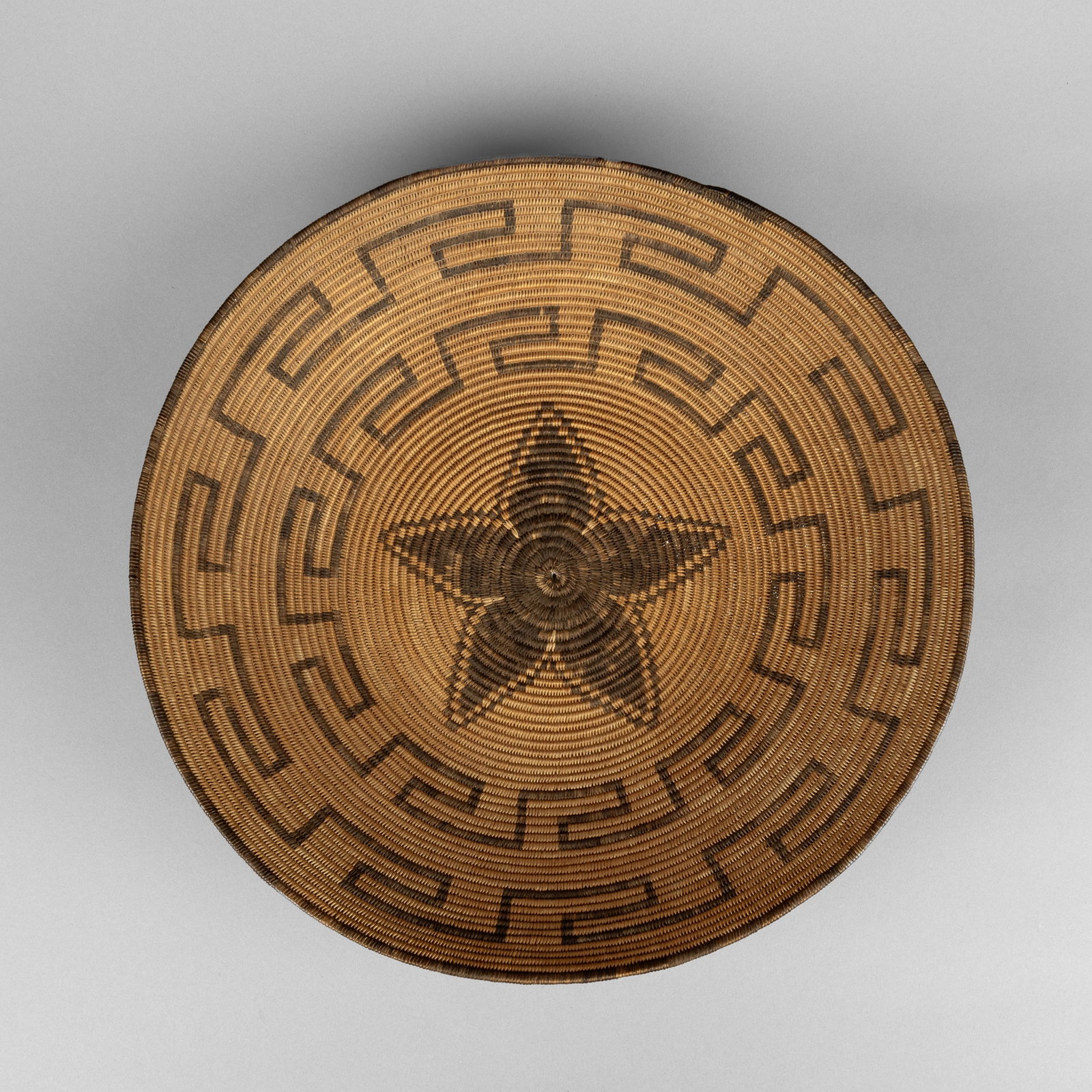 Apache, Basketry Bowl with Five Petal Design, ca. 1900: Apache Basketry Bowl with Five Petal Design, ca. 1900 natural fibers height: 4 x diameter: 17 in. (10.2 x 43.2 cm.) Private Collection, Pennsylvania
