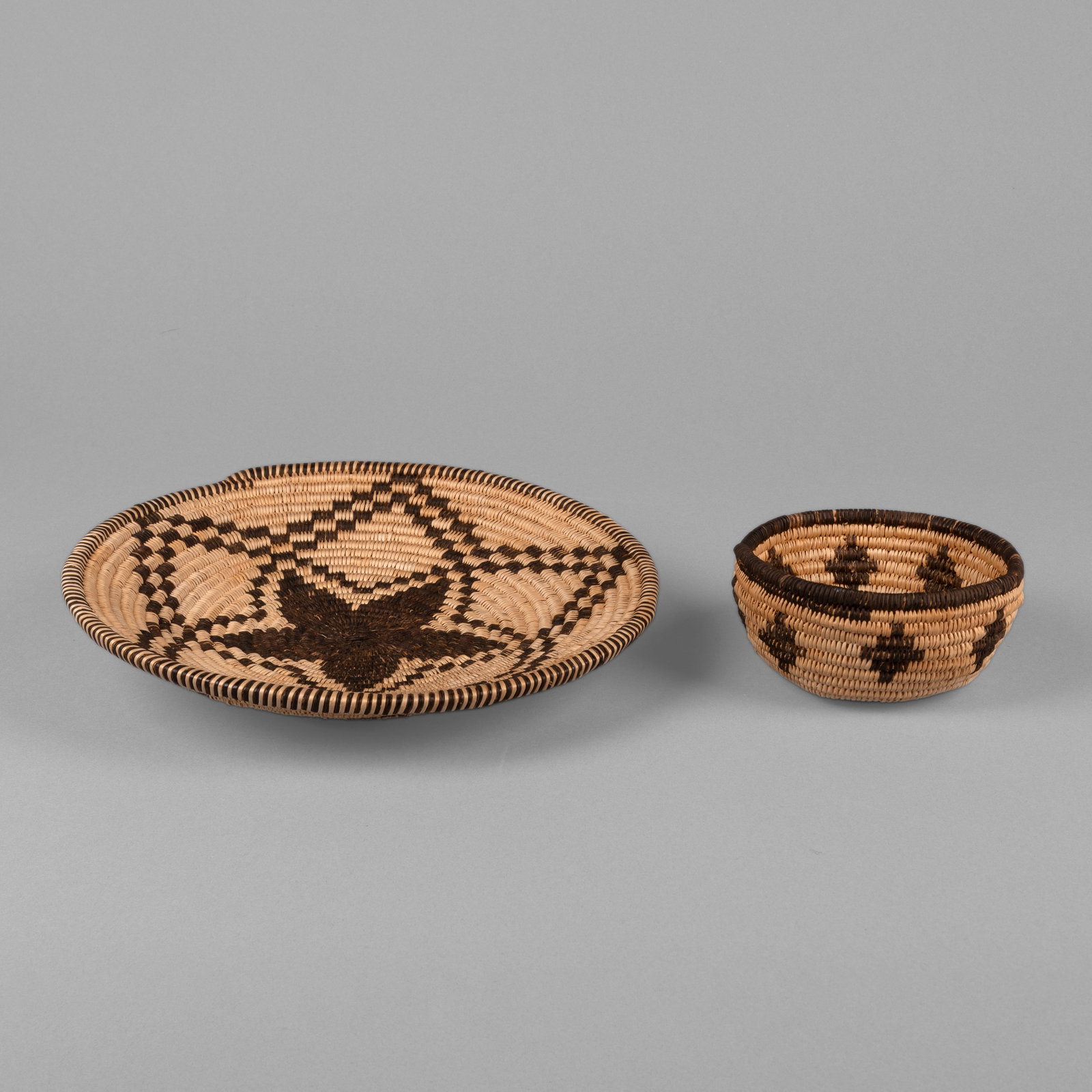 Apache, Two Baskets: Apache Two Baskets natural fibers larger height: 2 1/4 x diameter: 10 1/2 in. (5.7 x 26.7 cm.), smaller height: 2 1/2 x diameter: 4 3/4 in. (6.4 x 12.1 cm.) Private Collection, California