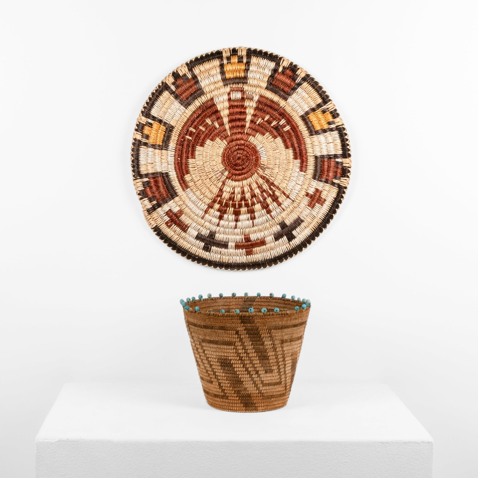 Two Basketry Works: Polychrome Plaque + Basket with Turquoise Rim: Two Basketry Works: Polychrome Plaque + Basket with Turquoise Rim natural fibers, turquoise plaque: 16 1/2 x 1 in. (41.9 x 2.5 cm.), basket: 7 3/8 x 9 1/4 in. (18.7 x 23.5 cm.) Private Collection,