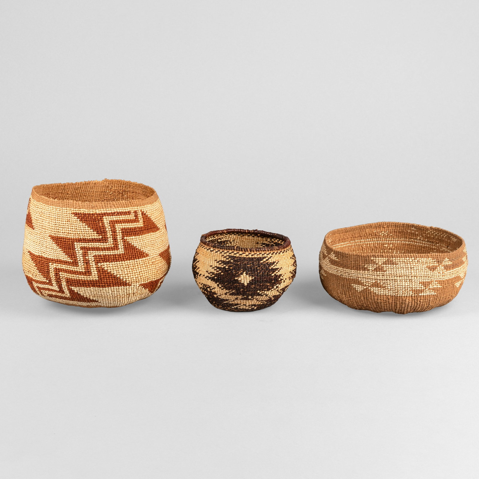 Yurok + Hupa + Pit River, Group of Three Baskets, ca. 1900 - 1920: Yurok + Hupa + Pit River Group of Three Baskets, ca. 1900 - 1920 natural fibers Yurok Twined Klamath River Basketry Bowl Hupa Acorn Mush Bowl with Geometric Design Pit River (Achumawi) Twined