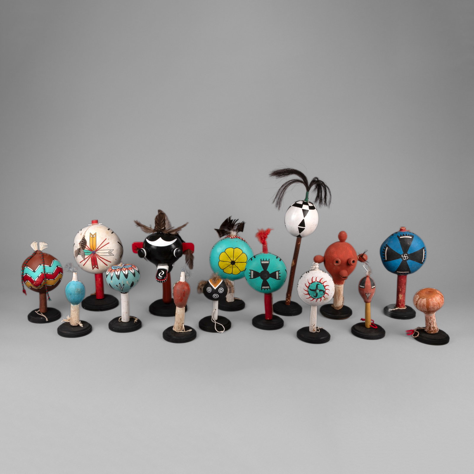 Group of Fifteen Contemporary Rattles: Group of Fifteen Contemporary Rattles painted gourd, carved and painted wood, feathers smallest: 6 1/8 x 3 7/8 in. (15.6 x 9.8 cm.), largest: 17 1/2 x 14 1/8 in. (44.5 x 35.9 cm.) Private Collection,