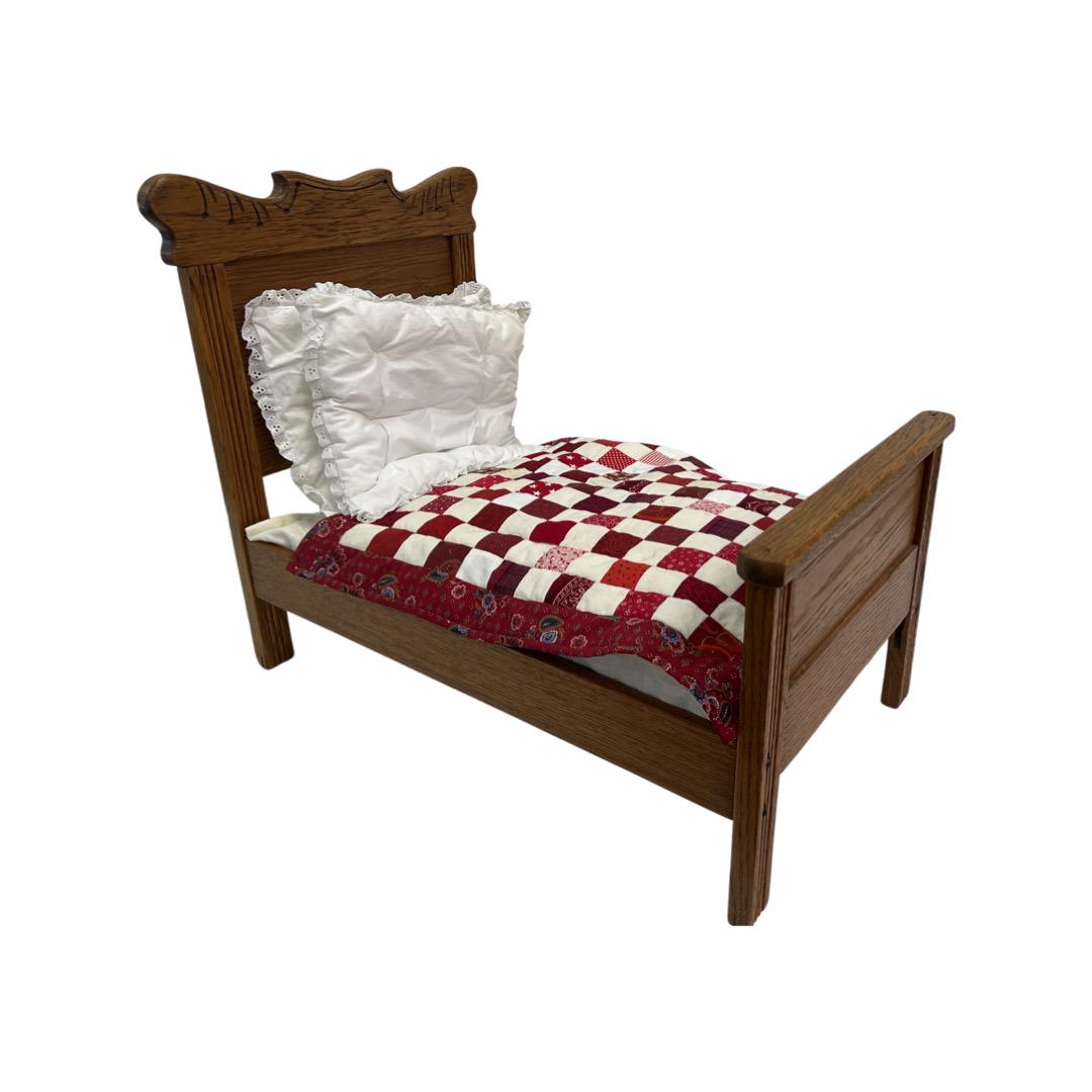 Antique Oak Large Doll Bed: Antique Oak Large Doll Bed, carved headboard, has mattress, quilt & 2 pillows. 17"W x 26"L x 21.5"H