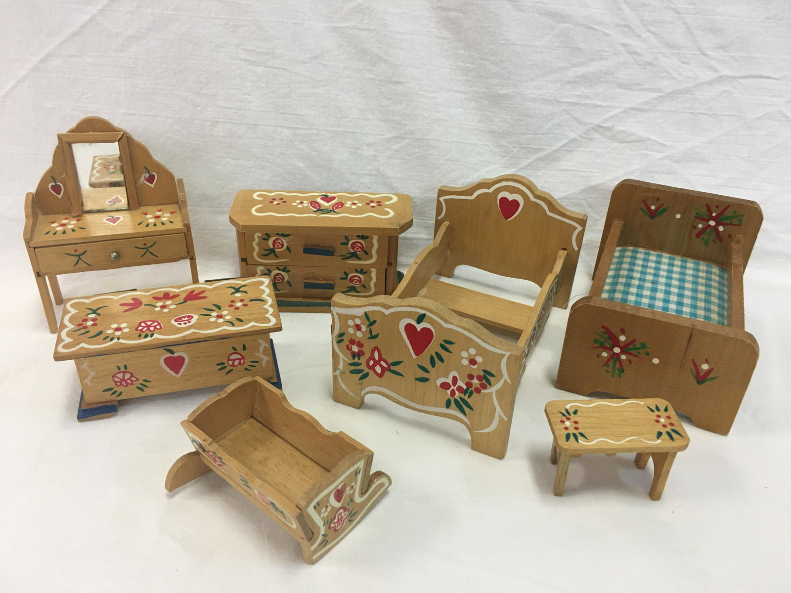 Group of Vintage Folk Painted Dollhouse Furniture: Group of Vintage Folk Painted Doll House Furniture. (7) pieces. Set of (6) pieces bedroom furniture includes bed, dressing table (missing trim piece around mirror), blanket chest, night table, chest o