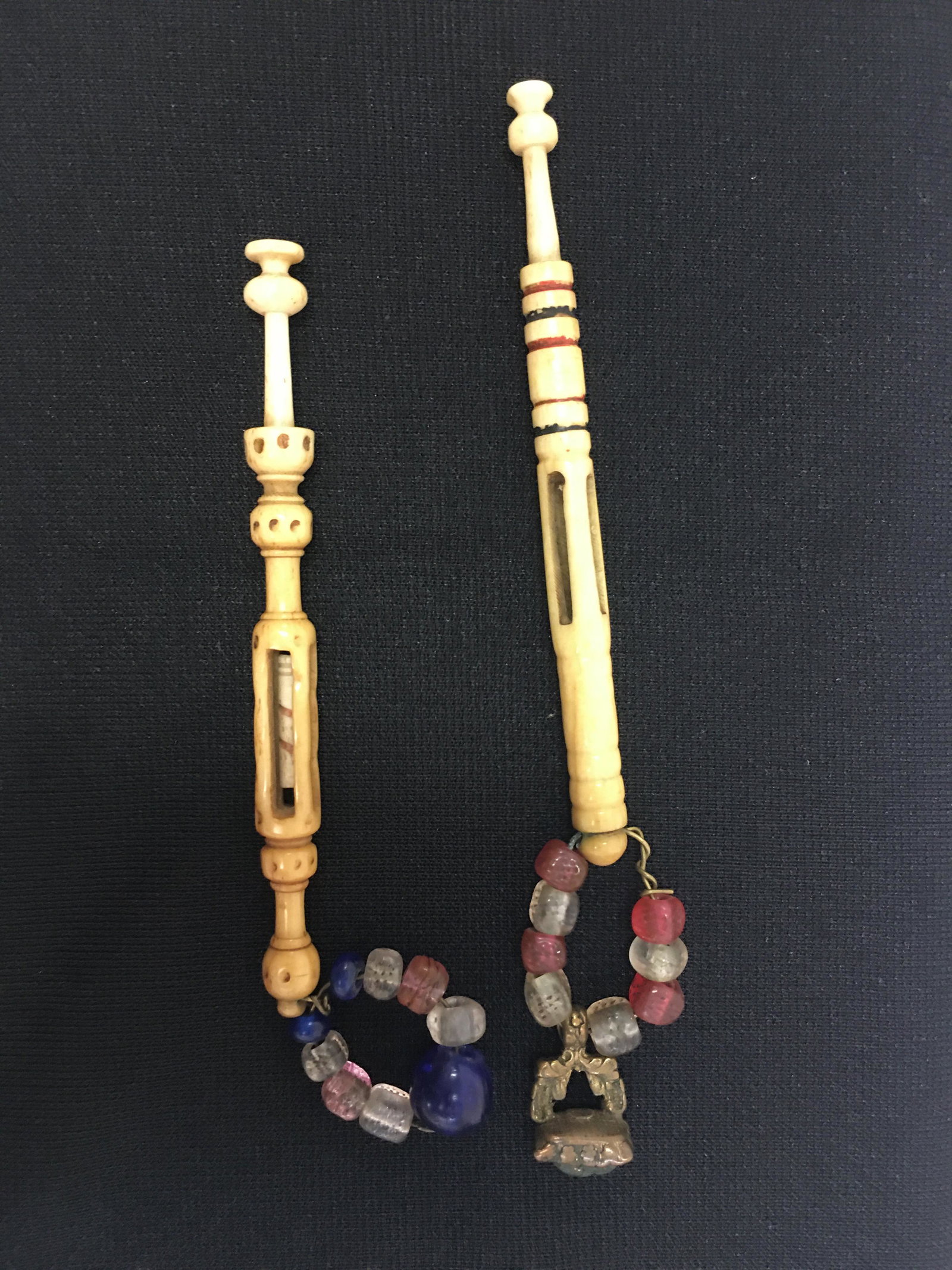 (2) Mother & Babe Antique Bobbins: (2) Antique Bone English Midland Mother and Babe Lace Spangled Bobbins. Both are spangled, one with spots and one with painted rings. No babe in ringed one and dotted babe is carved with a spiral. 3.7