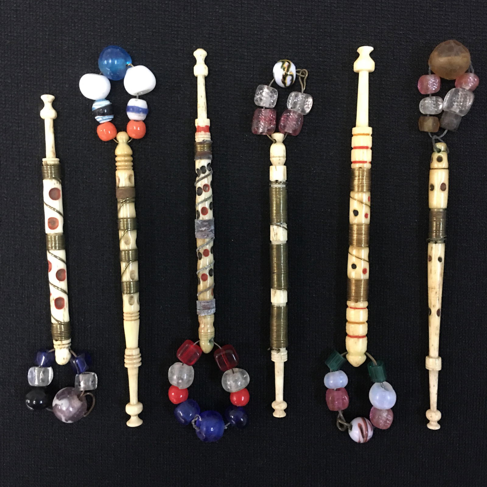 (6) English Antique Bone Bobbins: (6) English Midland Antique Bone Bobbins, Spangled and Wire Wrapped with colored dots and some rings. 3.5"-3.75"