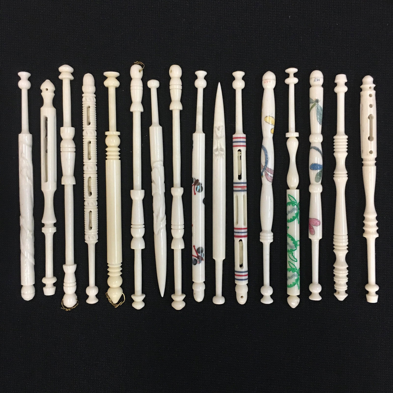 (16) Bone Turned Bobbins: (16) Bone Turned Bobbins, (4) painted, (4) Mother & Babe, (2) Signed MJ, 3.75"-4"