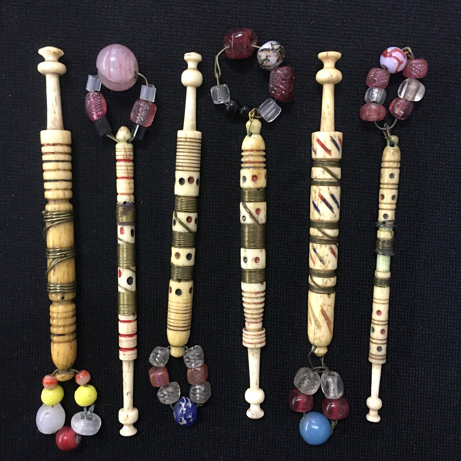 (6) Antique English Bone Wire Wrapped Lace Bobbins: (6) Antique English Bone Wire Wrapped Lace Bobbins, all spangled. Decorated with spots, rings & slashes. One head chipped. 3.5"-4"