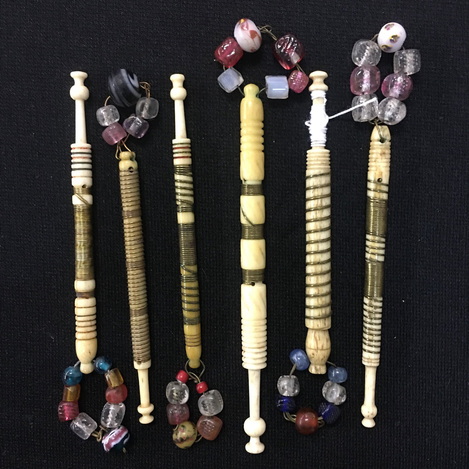(6) Antique English Bone Wire Wrapped Bobbins: (6) Antique English Bone Wire Wrapped Bobbins. All spangled, coil wrapped and/or with rings. 3.5"-4.25"