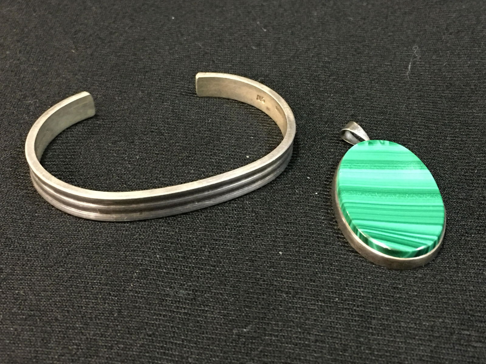 Colonial Williamsburg Sterling Cuff Bracelet and Malachite Pendant: Colonial Williamsburg Sterling Cuff Bracelet, marked CW Handwrought, 18g, 2.5" x 1.75". Sterling & malachite pendant