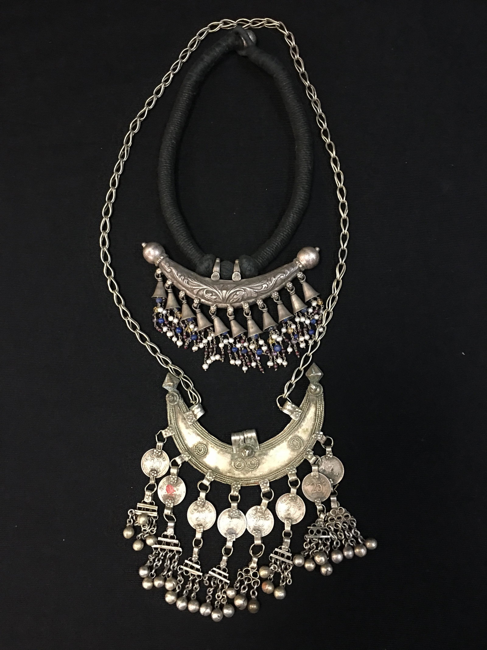 Vintage India Silver Necklaces: Vintage India Silver Necklaces, Chain link necklace with half moon pendant featuring India coins & bells fringe; Woven linen choker with silver crescent pendant having beaded bell fringe. Silver conte