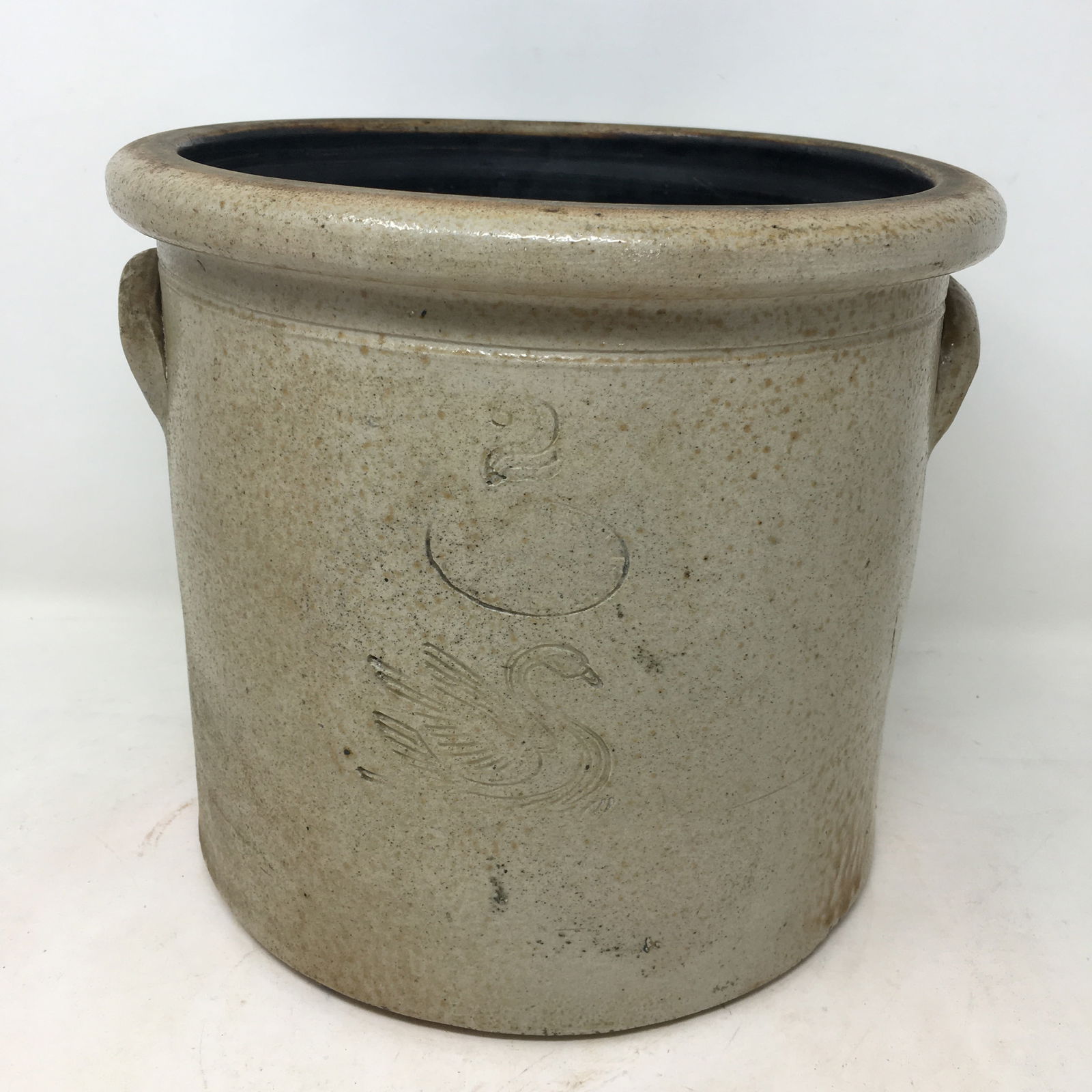 2 Gallon Swan Stoneware Crock: 2 Gallon Swan Stoneware Crock. Incised 2 and swan, with unreadable maker's mark. Base chip. 12.25"H x 8"W
