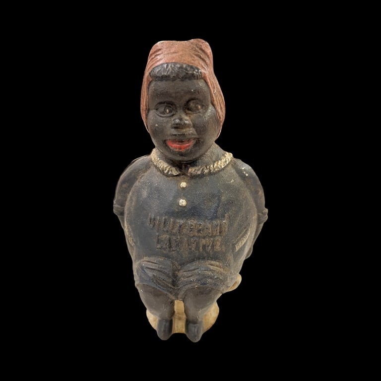 Black Americana Cast Iron Bank Advertising: Black Americana Cast Iron Bank mammy in blue with pink head scarf sitting on white pot. Advertising Dilly Brand Laxative.