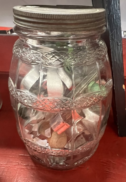 Glass Jar Full of Older Cookie Cutters: Glass Jar Full of Older Cookie Cutters including hatchet, flying flag with green handles, animals. Approx. 20 total.